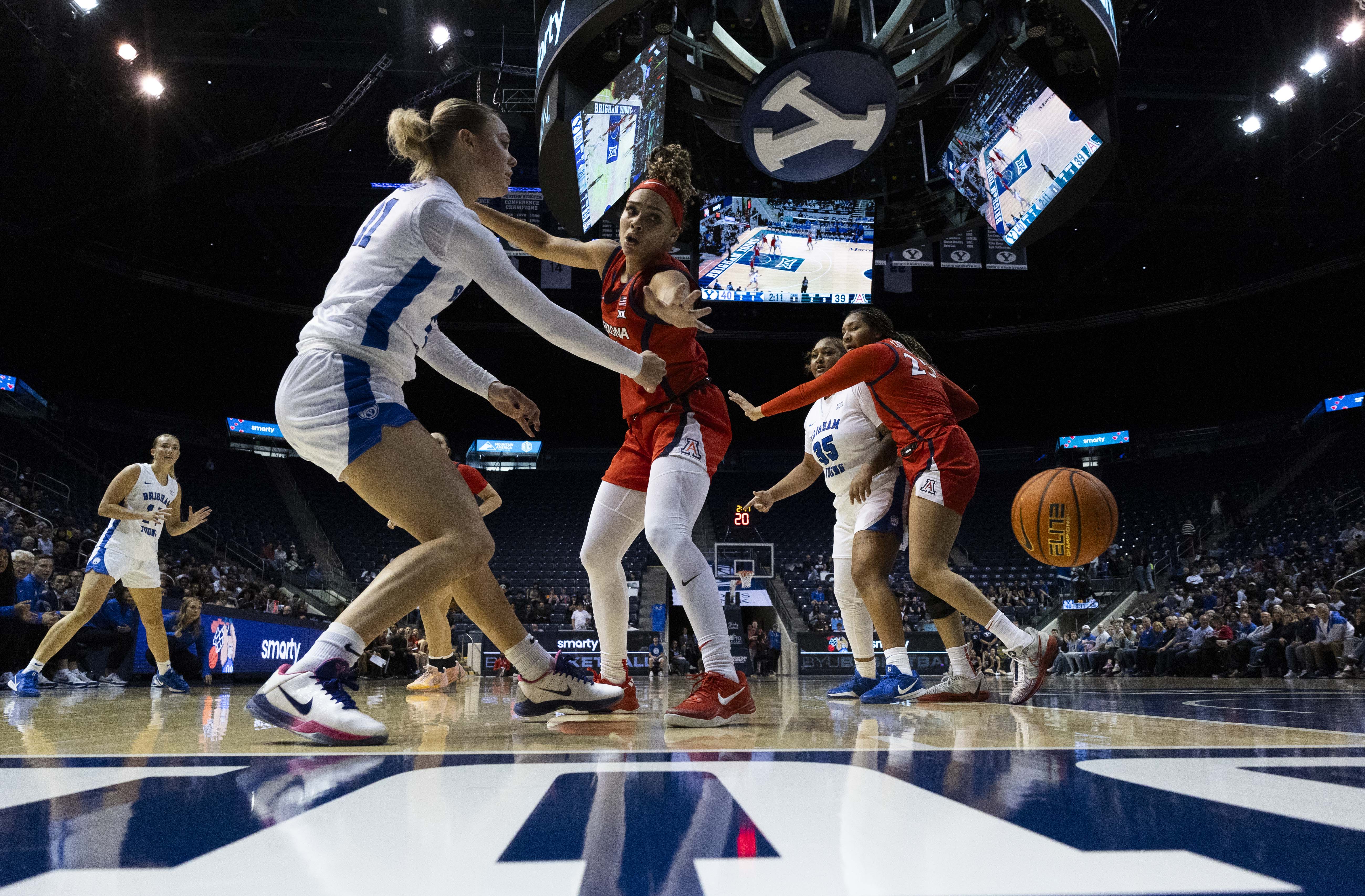 Arizona guard Jada Williams (2) watches as BYU guard Delaney Gibb (11) passes the ball during a game between BYU and the Arizona Wildcats at the Marriott Center on the campus of Brigham Young University in Provo on Saturday, Dec. 21, 2024.