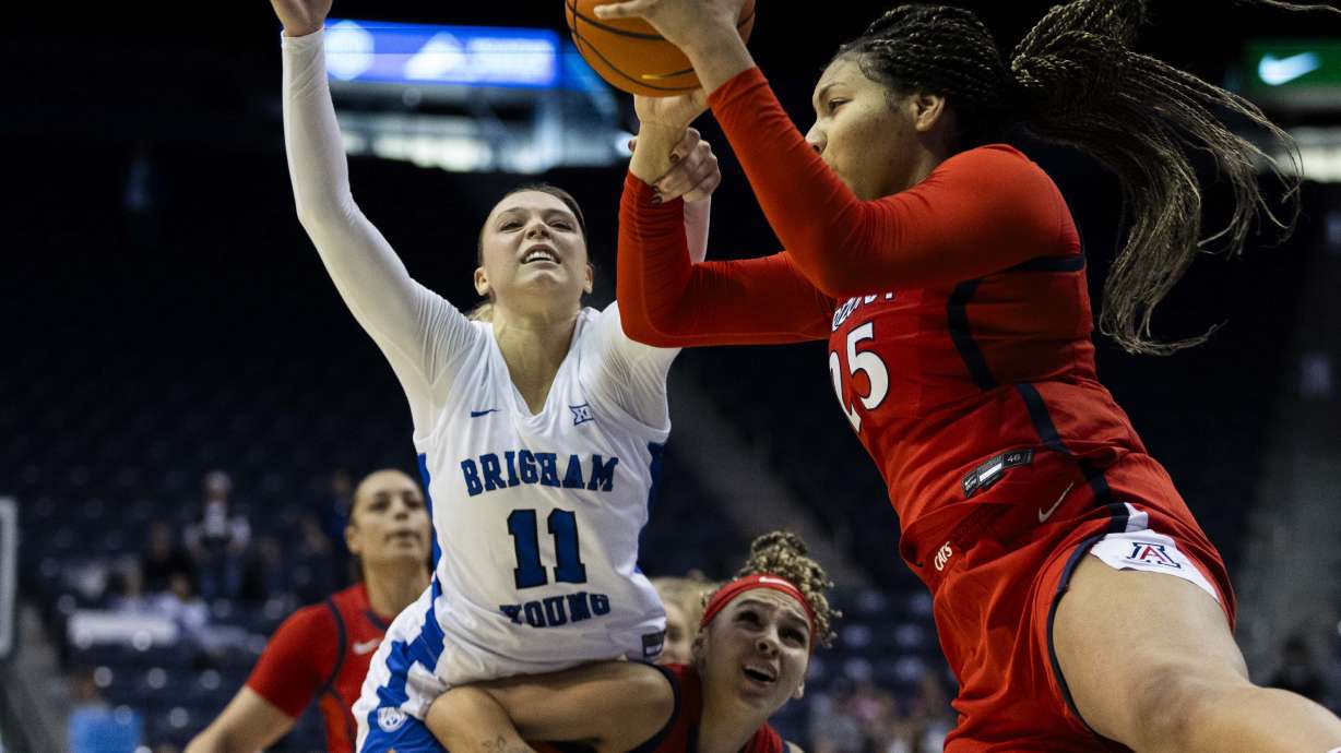 BYU guard Delaney Gibb (11) and Arizona forward Breya Cunningham (25) both reach for a rebound during a game between BYU and the Arizona Wildcats at the J. Willard Marriott Center on the campus of Brigham Young University in Provo on Saturday, Dec. 21, 2024.