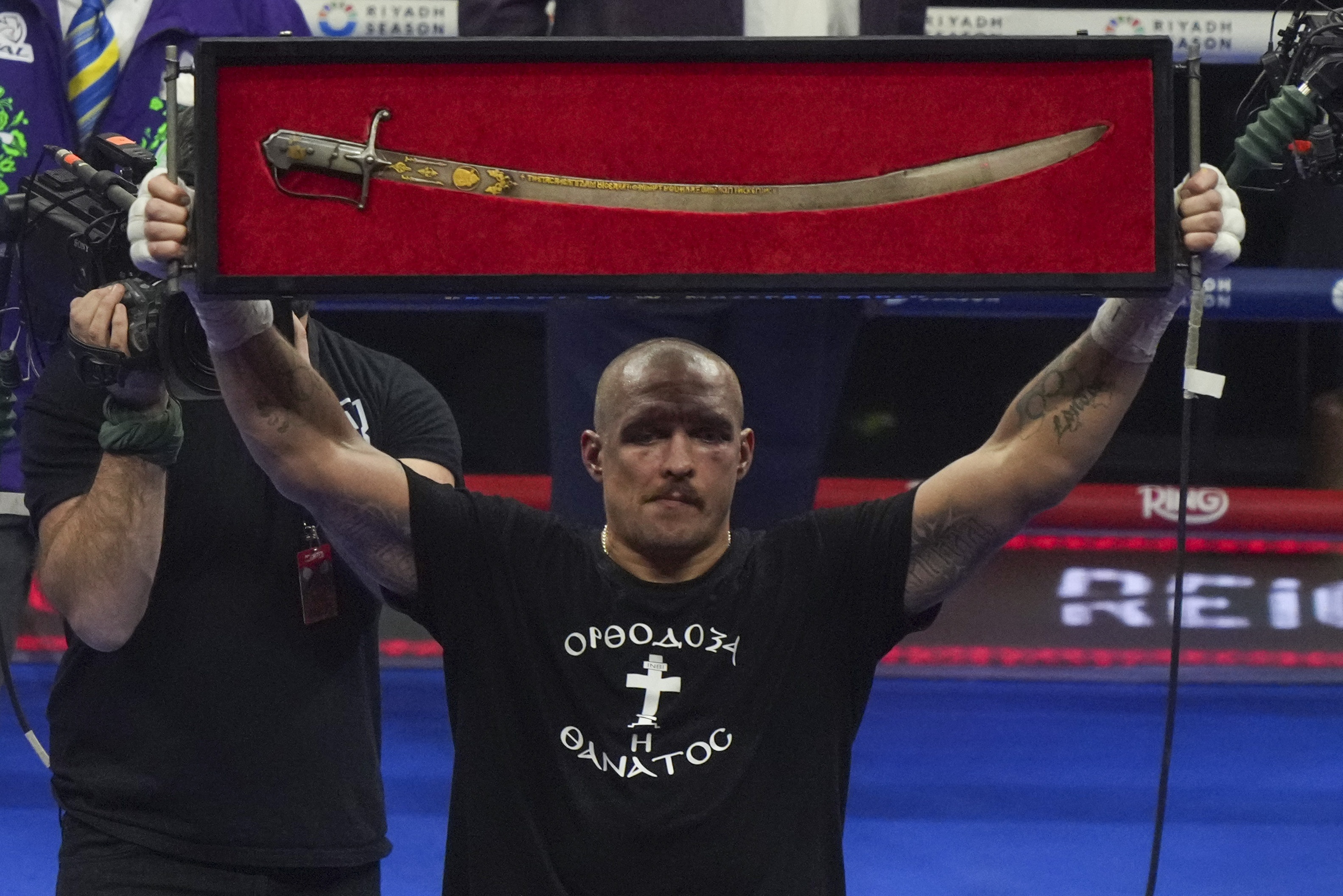 Ukraine's Oleksandr Usyk celebrates after winning the WBA, WBO, and WBC world heavyweight title fight against Britain's Tyson Fury in Riyadh, Saudi Arabia, Sunday, Dec. 22, 2024. 