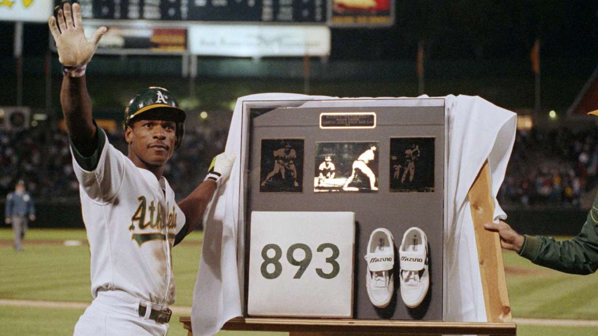 FILE - Rickey Henderson waves to the crowd during a presentation after he stole third base against the Toronto Blue Jays in the seventh inning to break Ty Cobb's career stolen base record, at Oakland Coliseum in Oakland, Calif., May 30, 1990.