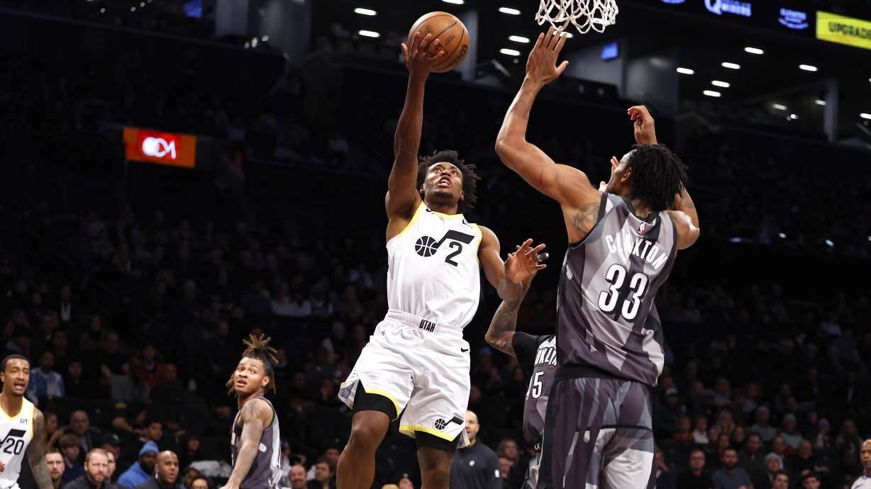 Utah Jazz guard Collin Sexton (2) drives to the basket against Brooklyn Nets center Nic Claxton (33) during the first half of an NBA basketball game, Saturday, Dec. 21, 2024, in New York.