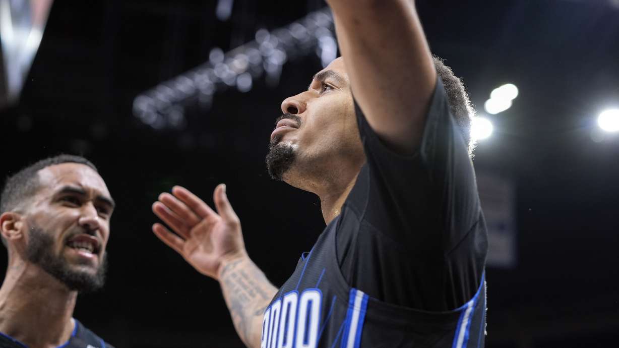 Orlando Magic guard Cole Anthony, right, celebrates a shot against the Miami Heat with teammate guard Trevelin Queen during the second half of an NBA basketball game, Saturday, Dec. 21, 2024, in Orlando, Fla.