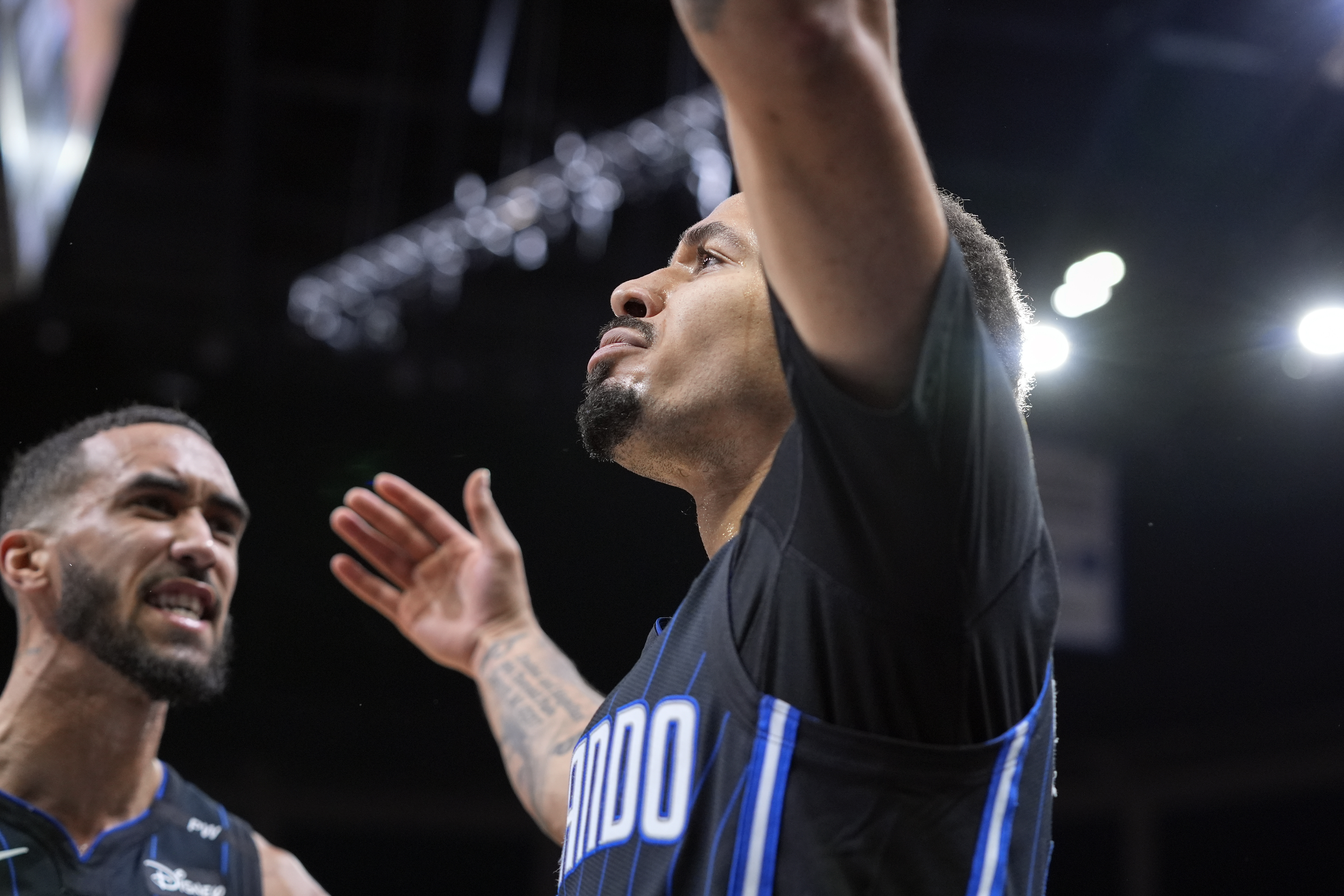 Orlando Magic guard Cole Anthony, right, celebrates a shot against the Miami Heat with teammate guard Trevelin Queen during the second half of an NBA basketball game, Saturday, Dec. 21, 2024, in Orlando, Fla.