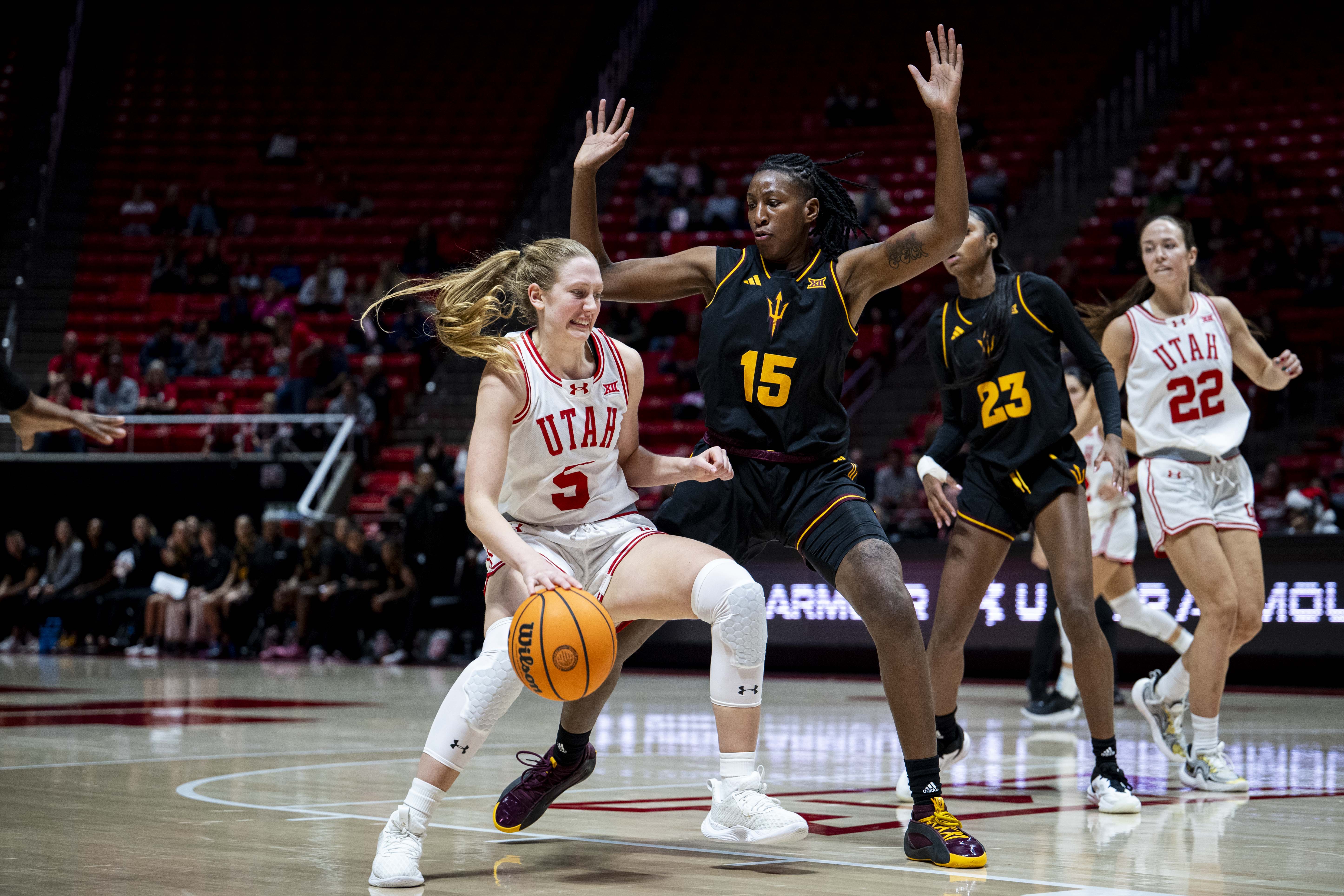 Utah Utes guard Gianna Kneepkens (5) drives the ball while guarded by Arizona State Sun Devils forward Heavenly Greer (15) during an NCAA women’s basketball game between the University of Utah and Arizona State University held at the Jon M. Huntsman Center in Salt Lake City on Saturday, Dec. 21, 2024.