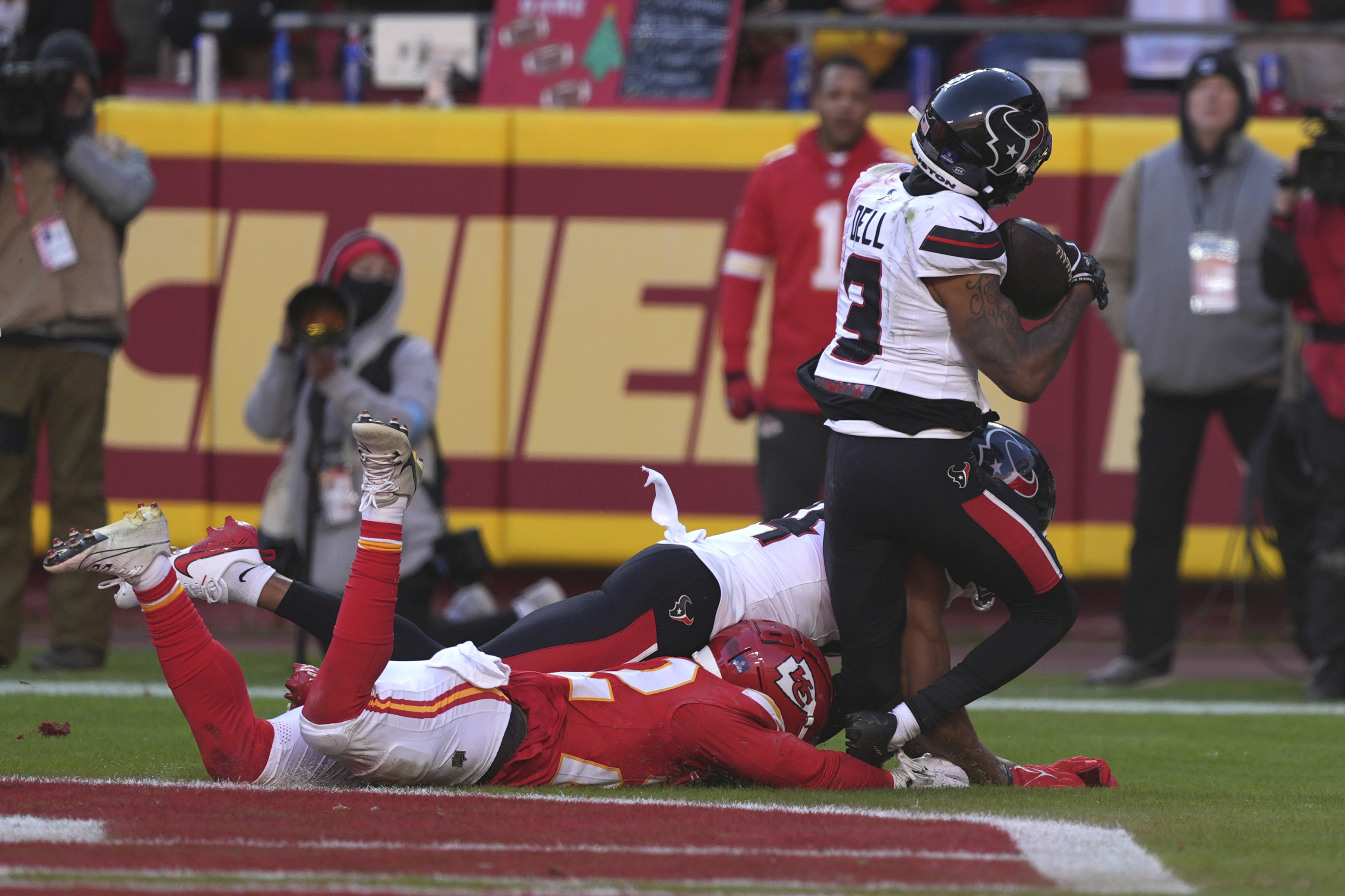 Houston Texans wide receiver Tank Dell (3) catches a touchdown pass as Kansas City Chiefs cornerback Trent McDuffie, left, defends during the second half of an NFL football game Saturday, Dec. 21, 2024, in Kansas City, Mo. Dell was injured on the play. 