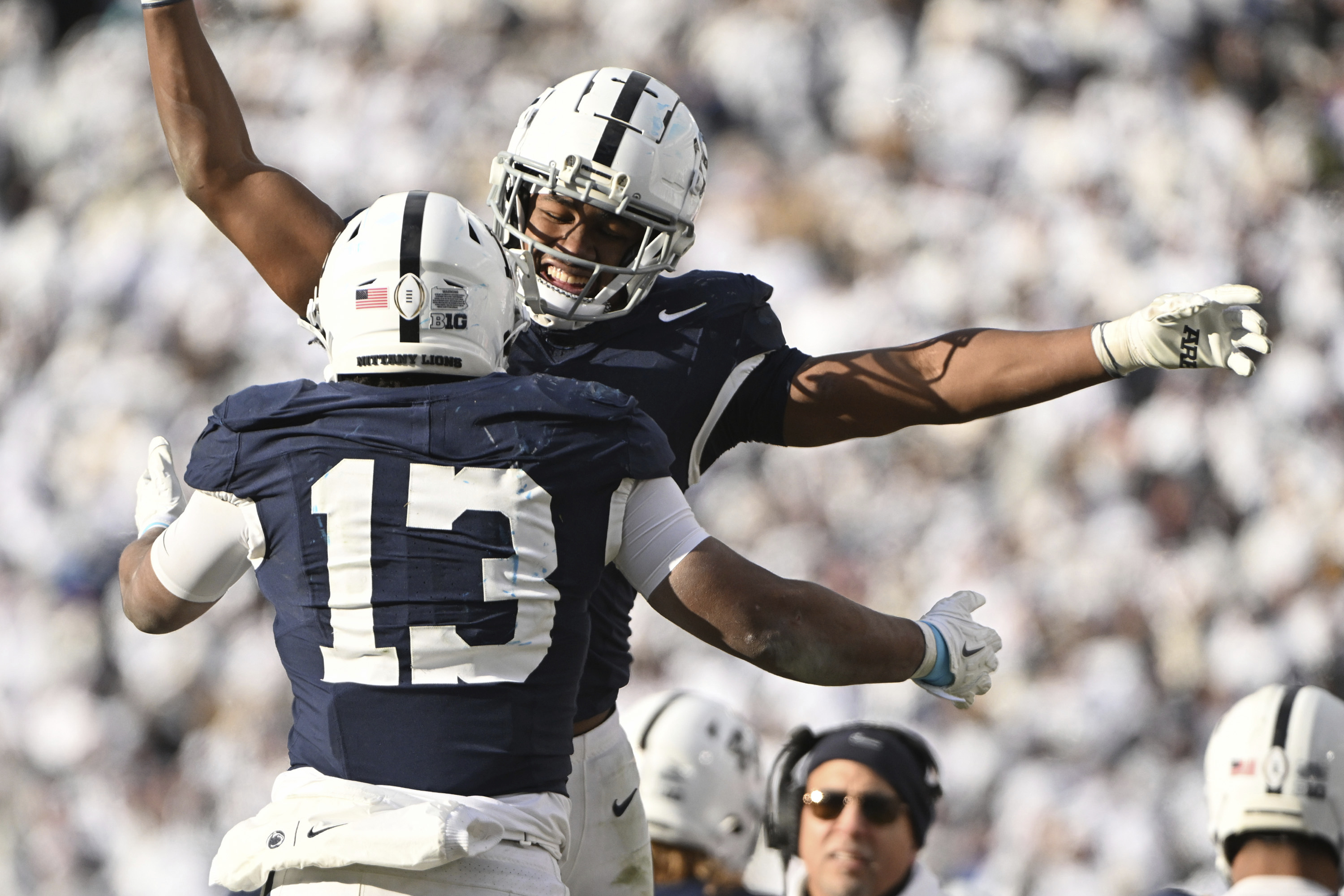 Penn State running back Kaytron Allen (13) celebrates after a touchdown with Nicholas Singleton, second from left, during the second half against SMU in the first round of the College Football Playoff, Saturday, Dec. 21, 2024, in State College, Pa. 