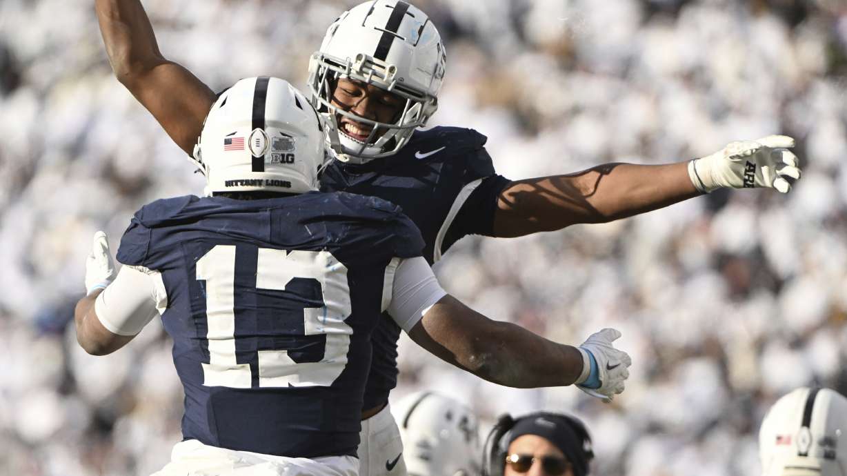Penn State running back Kaytron Allen (13) celebrates after a touchdown with Nicholas Singleton, second from left, during the second half against SMU in the first round of the College Football Playoff, Saturday, Dec. 21, 2024, in State College, Pa.