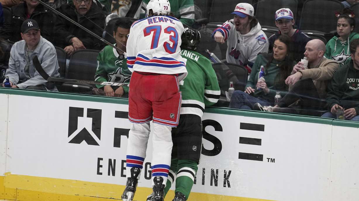New York Rangers center Matt Rempe (73), who was ejected for game misconduct, slams Dallas Stars' Miro Heiskanen (4) against the boards in the third period of an NHL hockey game in Dallas, Friday, Dec. 20, 2024.