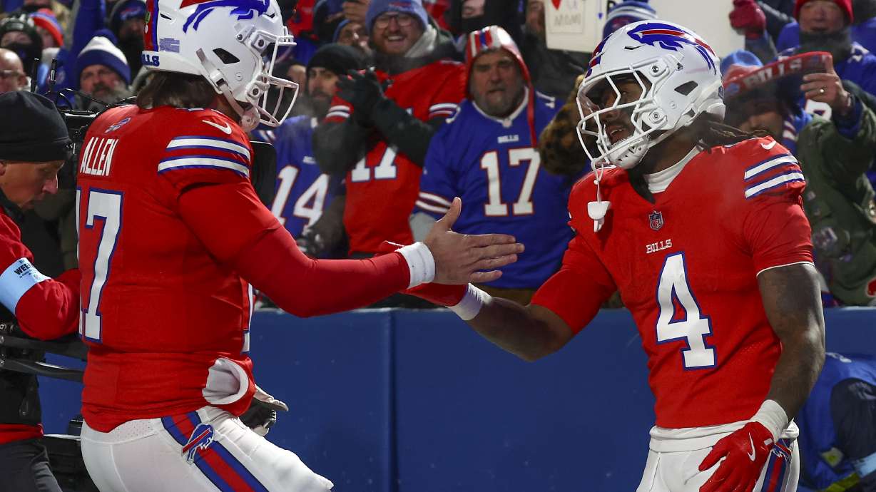 Buffalo Bills quarterback Josh Allen (17) congratulates Buffalo Bills running back James Cook (4) after a touchdown against the New England Patriots during the third quarter of an NFL football game, Sunday, Dec. 22, 2024, in Orchard Park, N.Y..