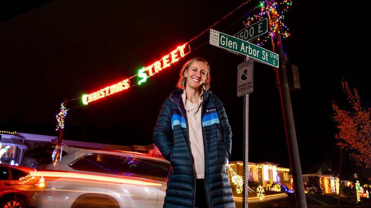Emma Thatcher poses for a portrait along Glen Arbor Street, nicknamed “Christmas Street,” in Salt Lake City on Dec. 12. Thatcher and her family have lived on the street for four years.