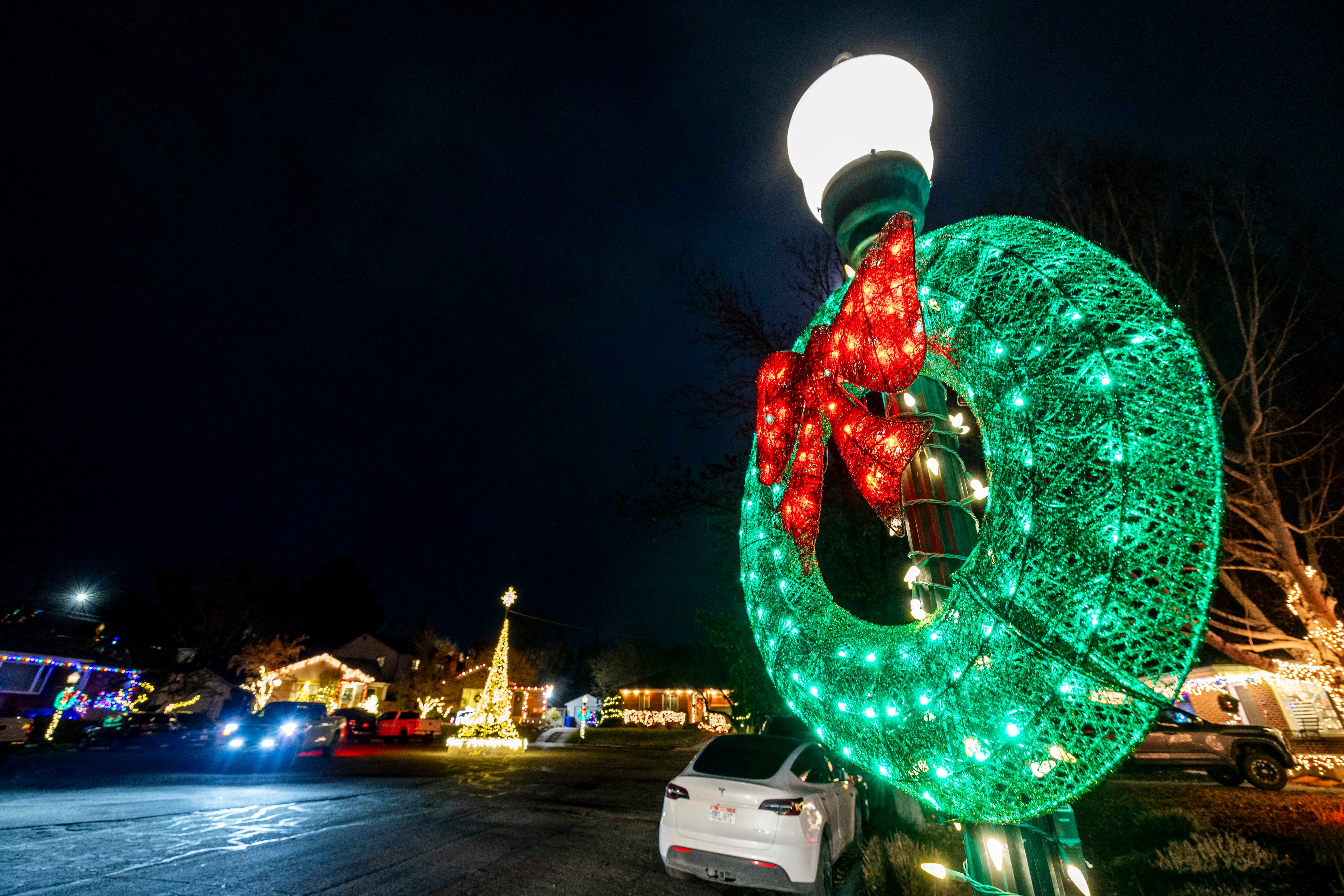 A car rounds a Christmas light tree at the end of the cul-de-sac on Glen Arbor Street, nicknamed “Christmas Street,” in Salt Lake City on Thursday, Dec. 12, 2024.
