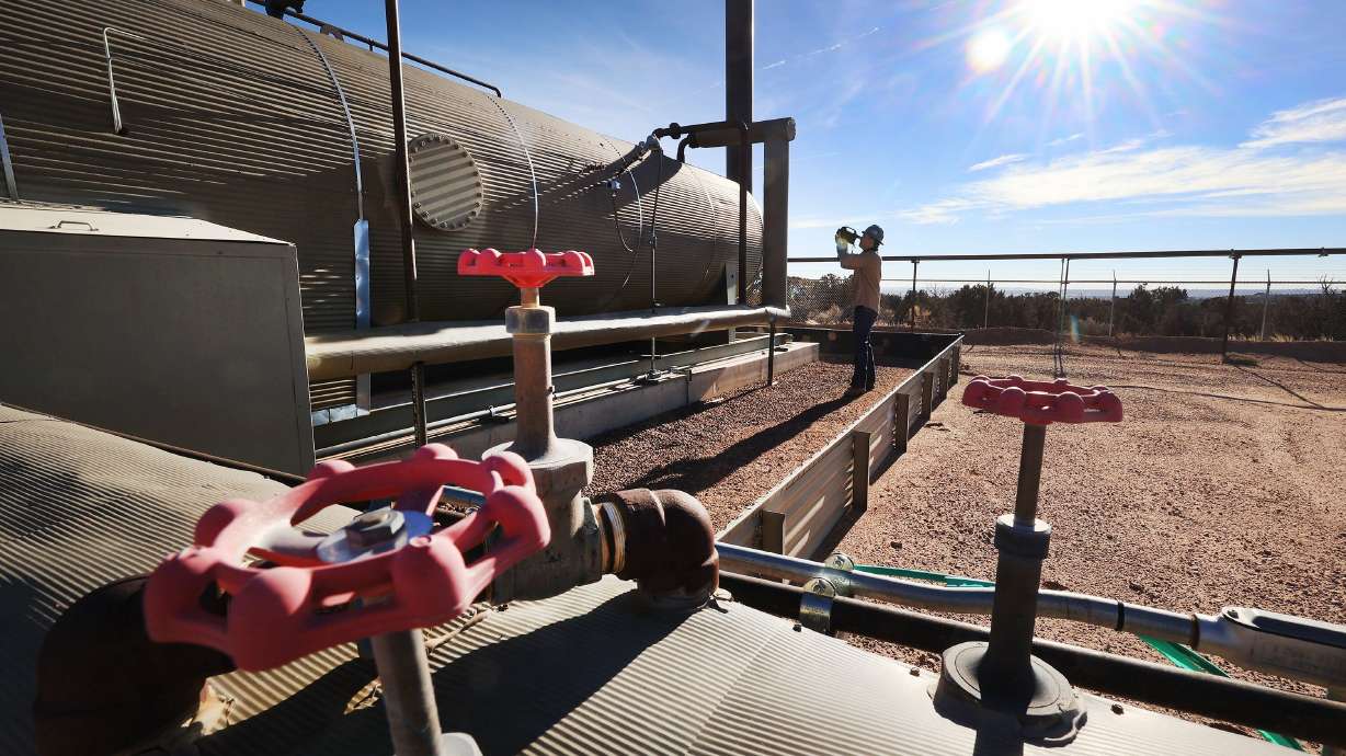 Stephen Foulger, an environmental scientist with the Utah Department of Environmental Quality, inspects an oil pump site near Roosevelt on Dec. 1, 2021.