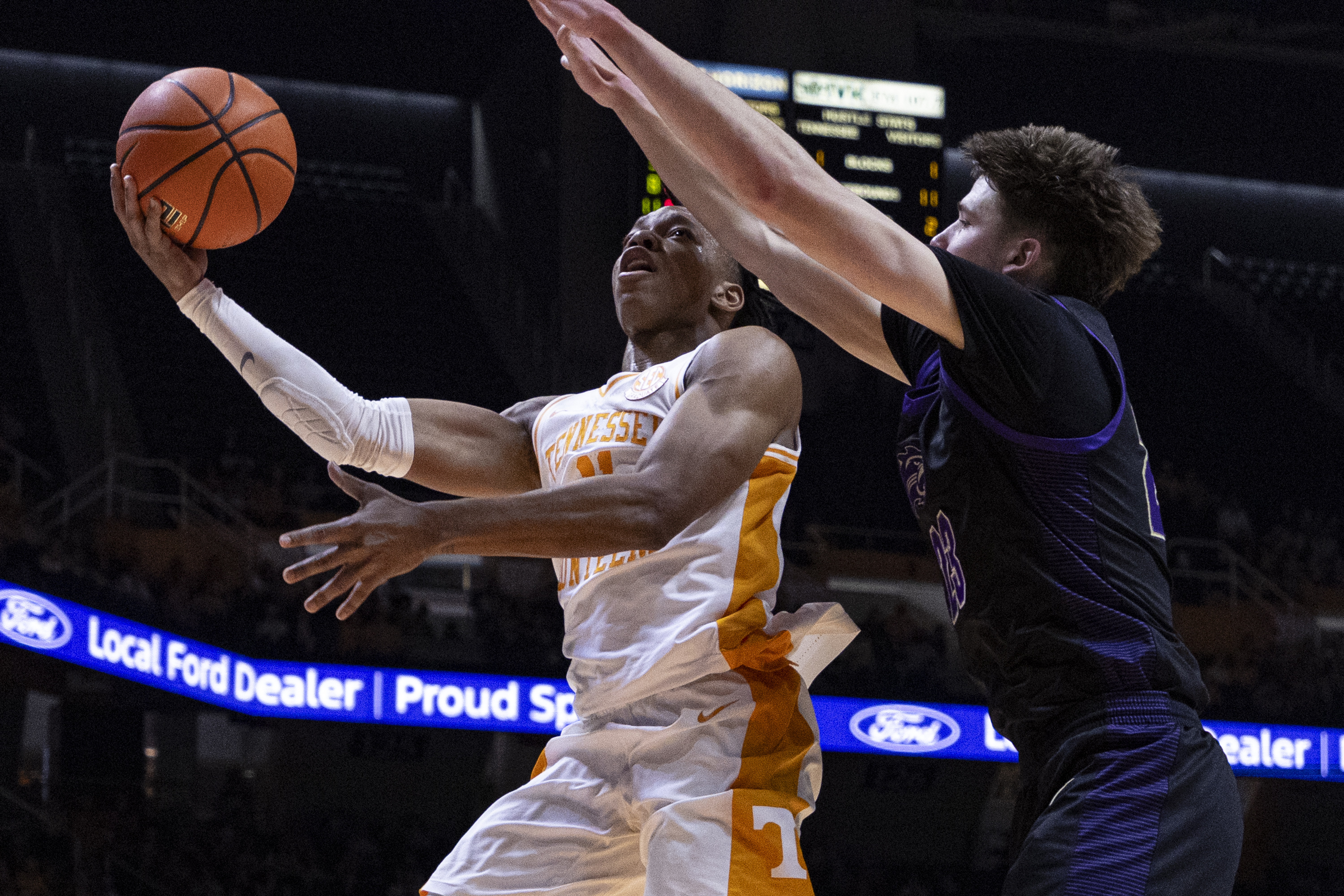 Tennessee guard Jordan Gainey (11) shoots past Western Carolina forward Marcus Kell (23) during the first half of an NCAA college basketball game Tuesday, Dec. 17, 2024, in Knoxville, Tenn. 