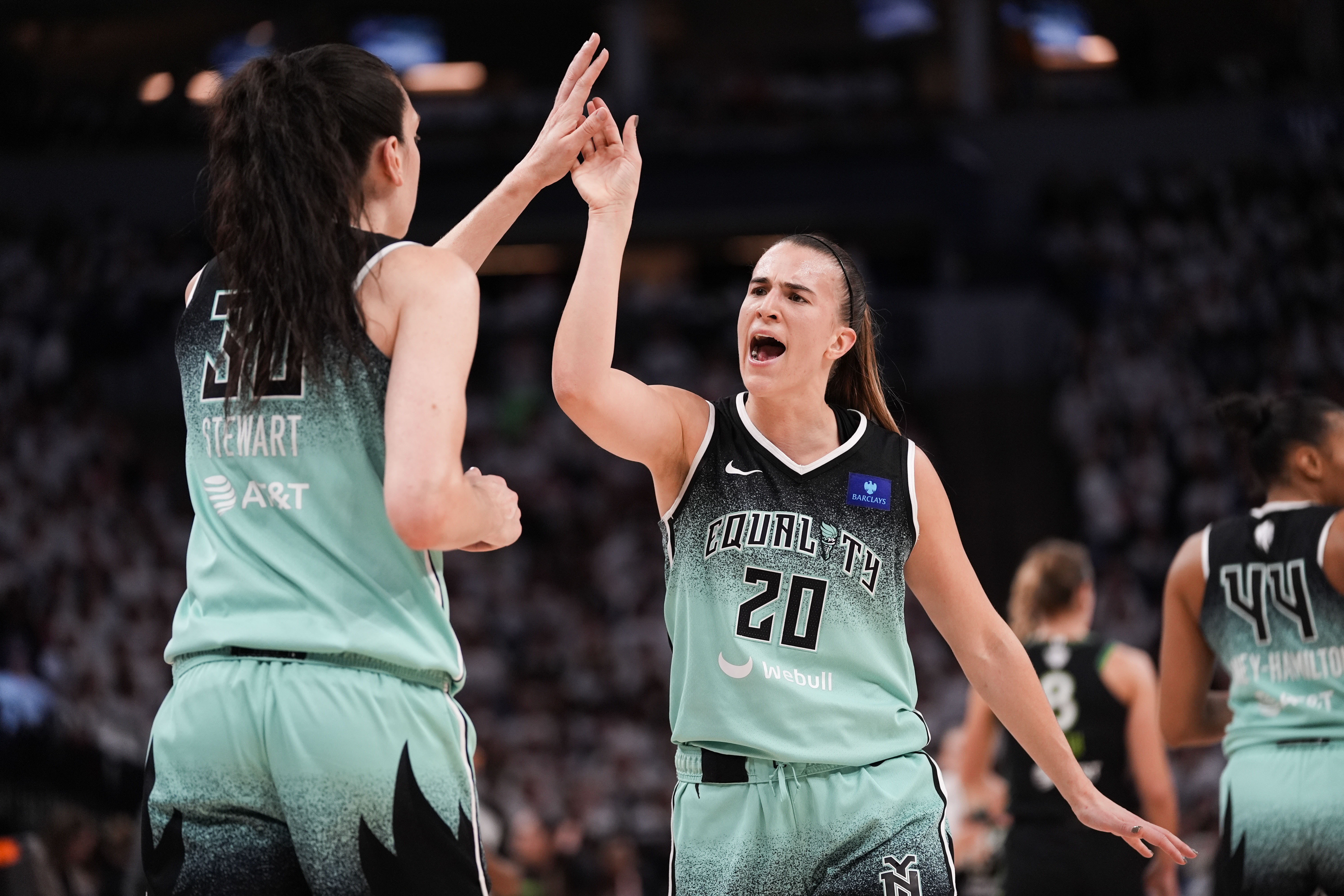 FILE - New York Liberty guard Sabrina Ionescu (20) reacts with forward Breanna Stewart (30) at the end of the first half of Game 4 of a WNBA basketball final playoff series against the Minnesota Lynx, Friday, Oct. 18, 2024, in Minneapolis. 