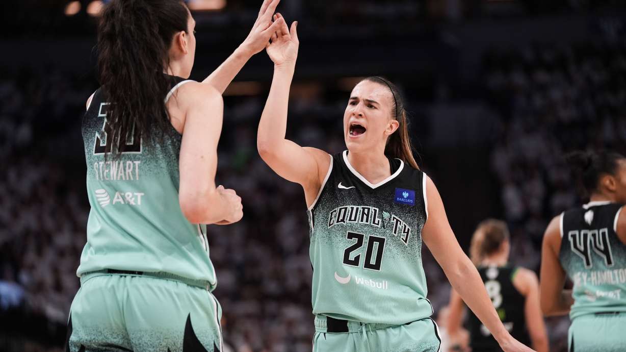 FILE - New York Liberty guard Sabrina Ionescu (20) reacts with forward Breanna Stewart (30) at the end of the first half of Game 4 of a WNBA basketball final playoff series against the Minnesota Lynx, Friday, Oct. 18, 2024, in Minneapolis.