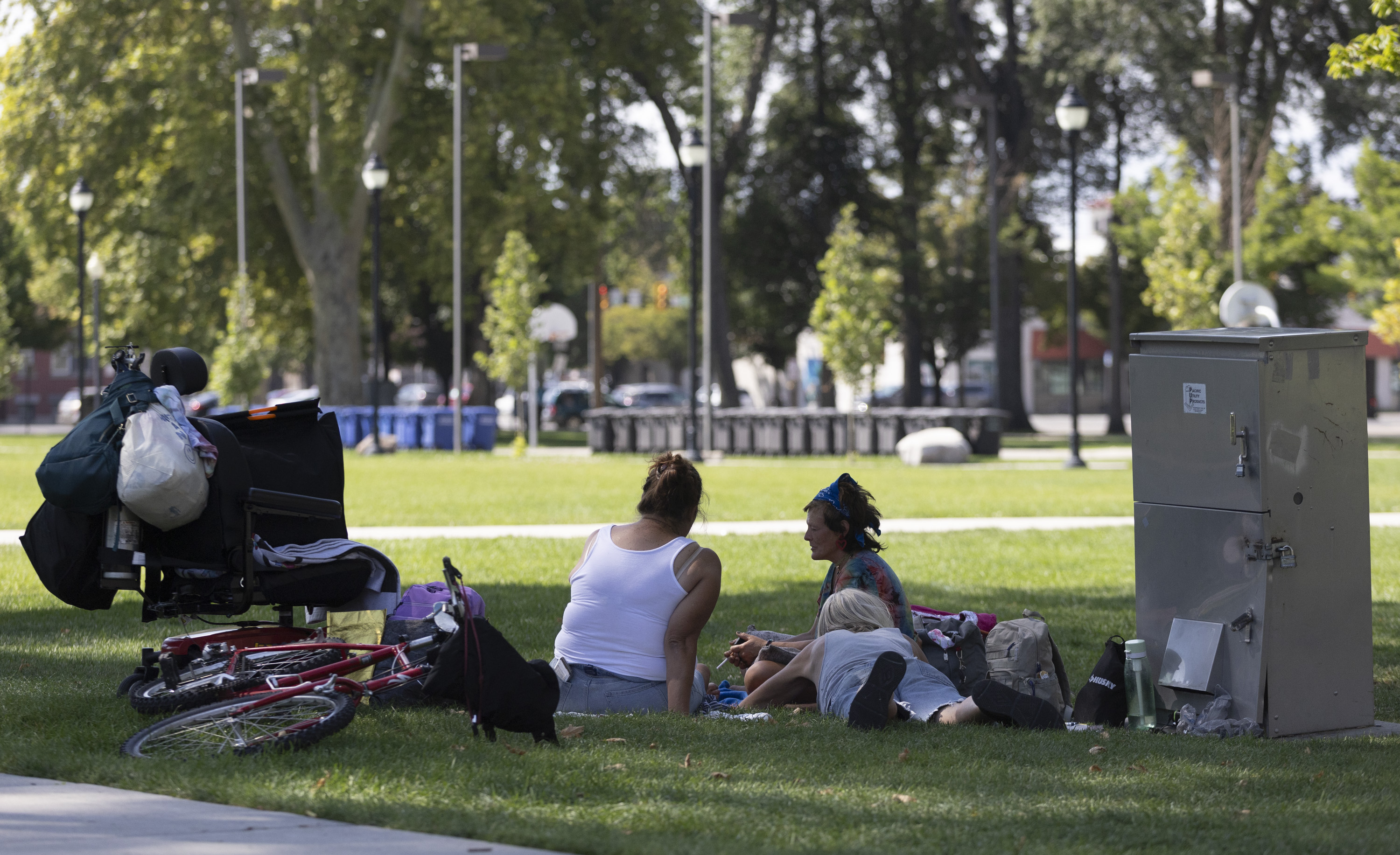 Stephanie Duffield, center, who has been homeless for three years, sits, talks and rests with friends in Pioneer Park in Salt Lake City on Sept. 9. Salt Lake City leaders anticipate new legislation on homelessness will be taken up in the 2025 legislative session.