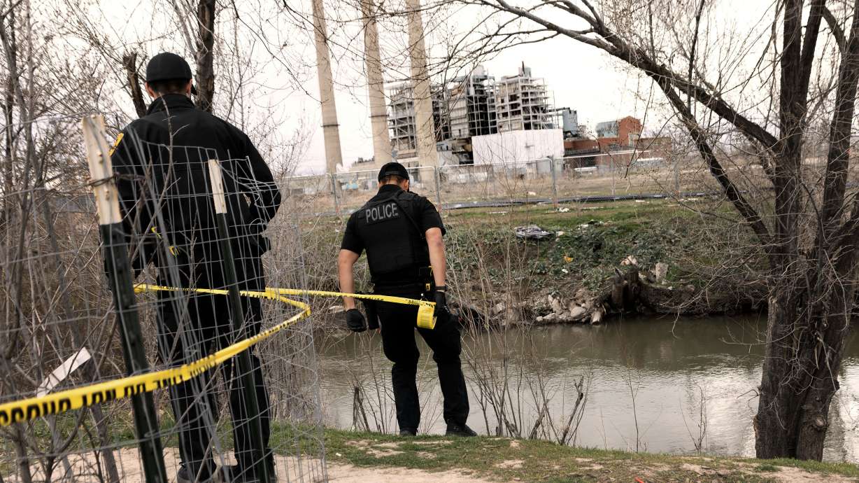 A Salt Lake police officer tapes off a crime scene by the Jordan River near Rocky Mountain Power in Salt Lake City on March 22. Utah leaders called on Salt Lake City to address policing and criminal justice "inadequacies" in a letter this month.