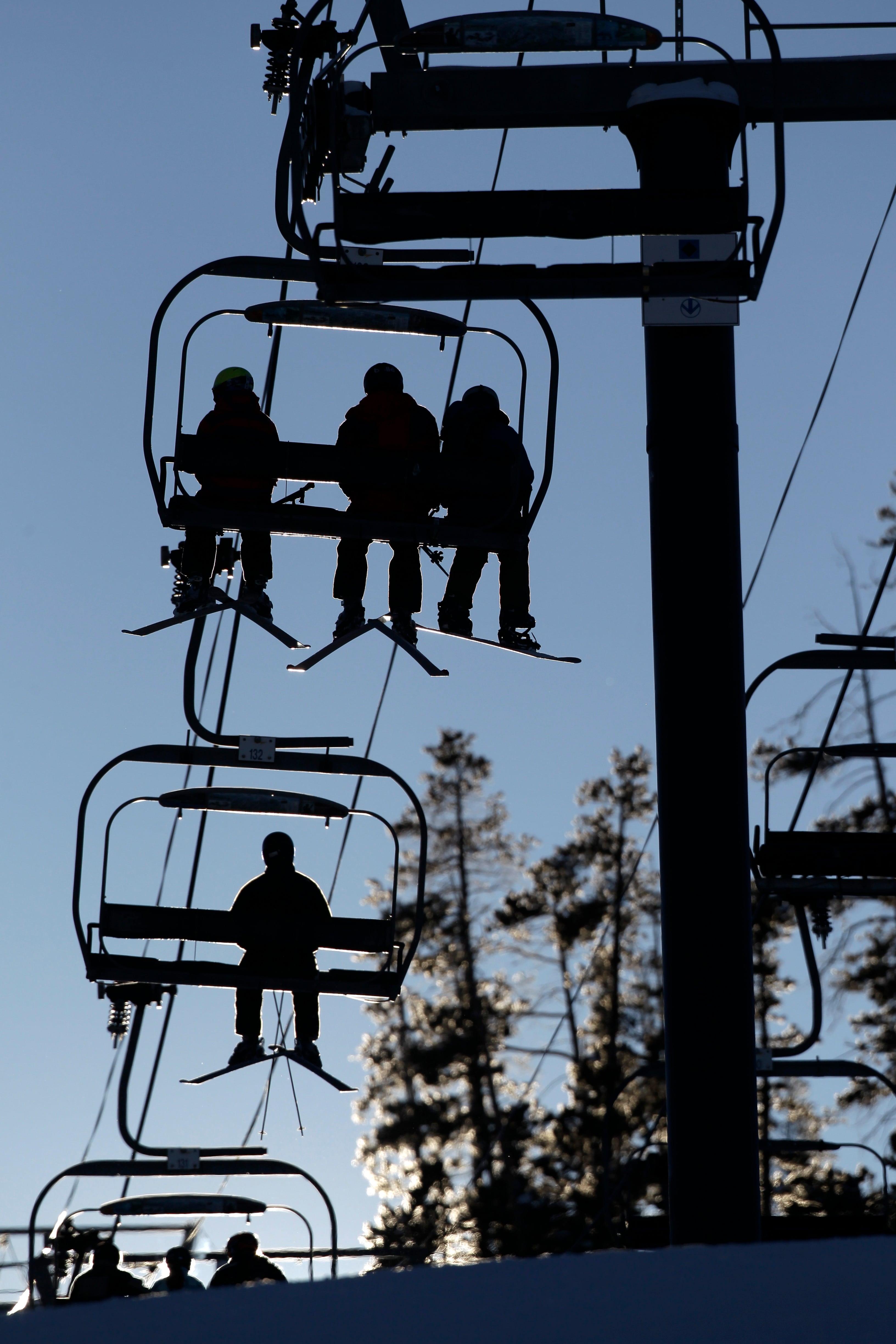 Skiers and snowboarders ride a lift at Winter Park Resort in Winter Park, Colo., Dec. 20, 2012.