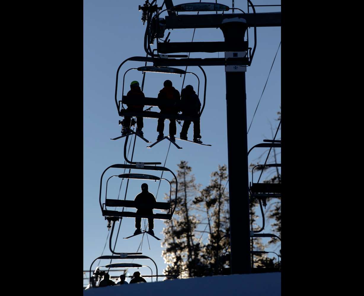 Skiers and snowboarders ride a lift at Winter Park Resort in Winter Park, Colo., Dec. 20, 2012.