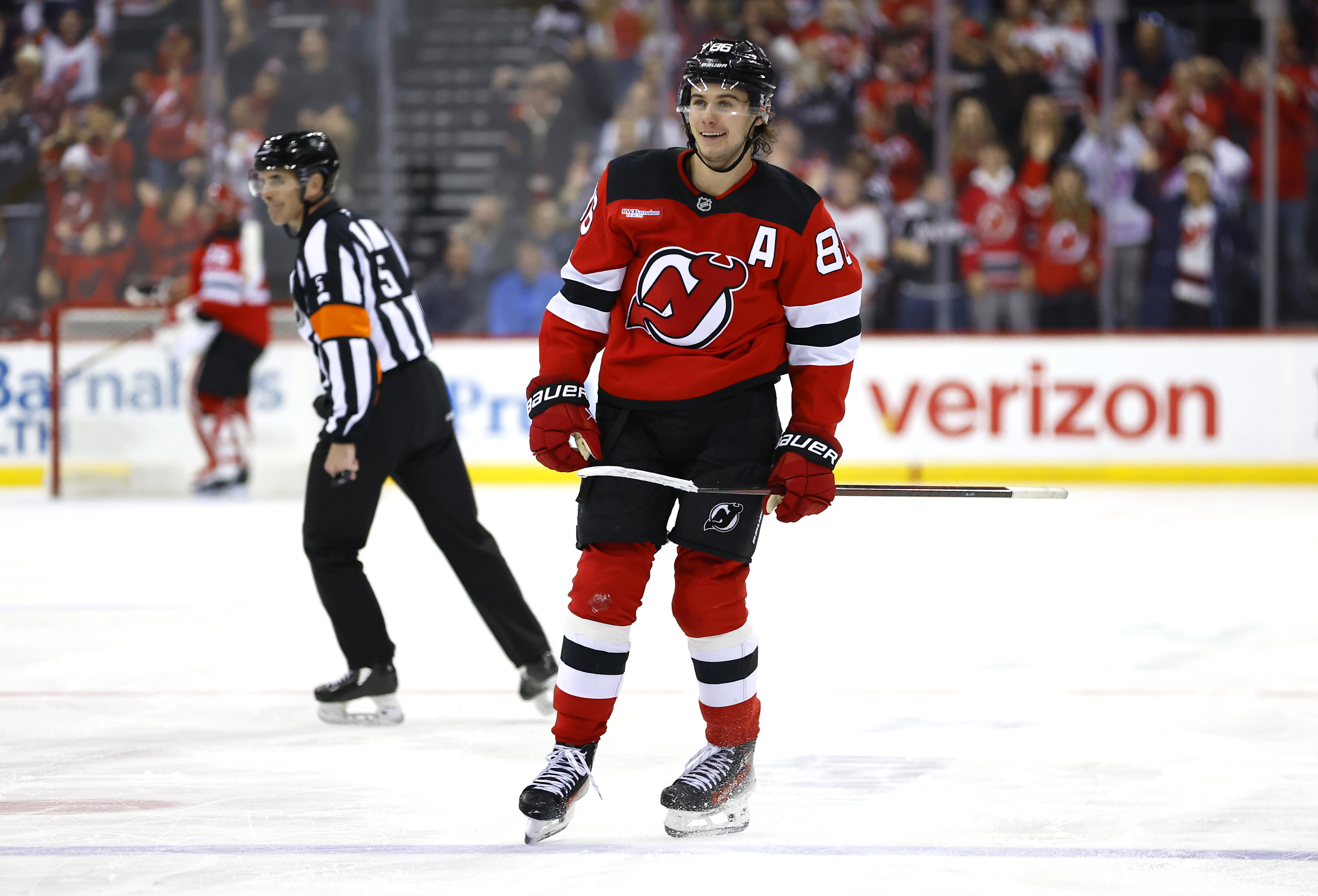 New Jersey Devils center Jack Hughes (86) reacts after scoring a goal against the New York Rangers during the second period of an NHL hockey game, Monday, Dec. 23, 2024, in Newark, N.J.