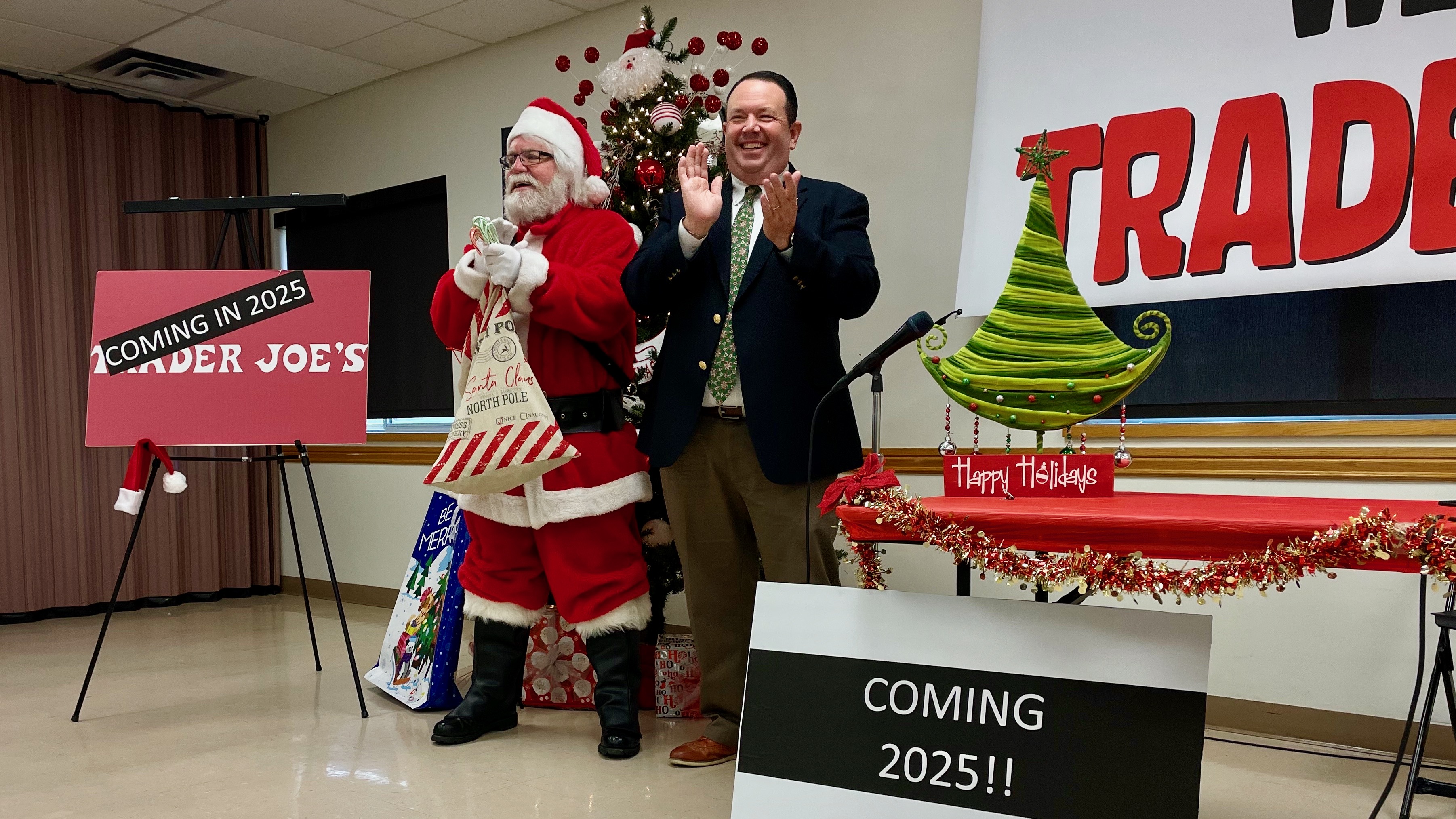 Riverdale Mayor Braden Mitchell and Santa Claus at the announcement on Monday of the planned opening of a Trader Joe's in the city, probably in June.