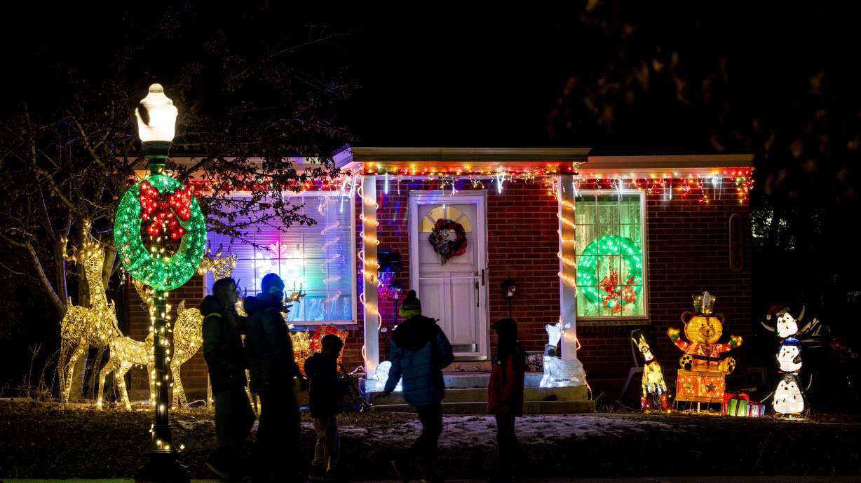 Glen Arbor Street residents pass Christmas lights and decorations along the street, nicknamed “Christmas Street,” in Salt Lake City on Dec. 12. Salt Lake City and other Utah communities could receive snow between Christmas Eve and Christmas Day.