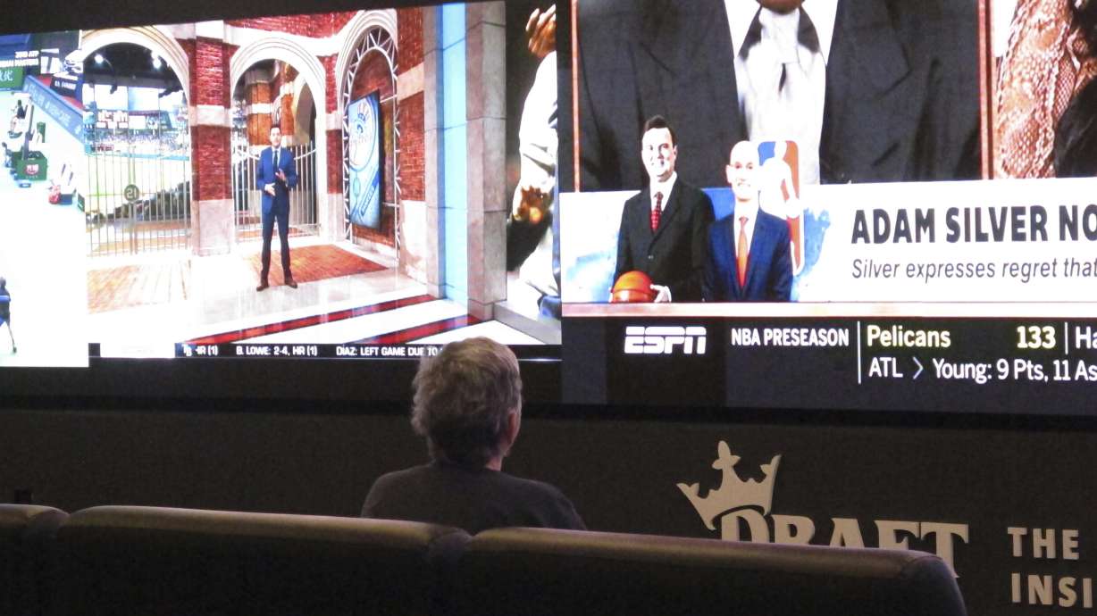 A customer watches video screens inside the DraftKings sportsbook in Atlantic City N.J. on Oct. 8, 2019.