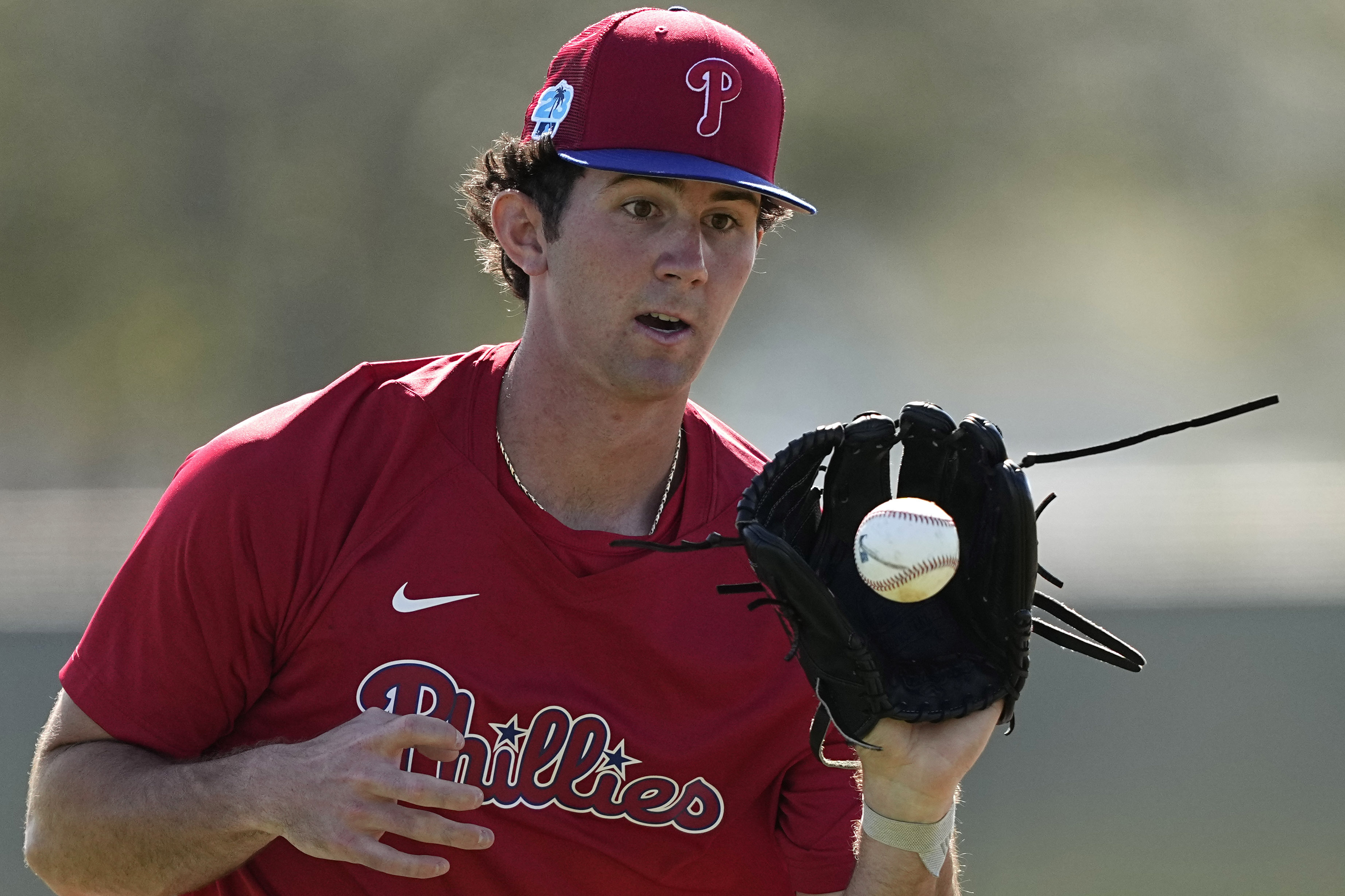 FILE - Philadelphia Phillies Andrew Painter fields a ground ball during a spring training baseball workout, Feb. 21, 2023, in Clearwater, Fla.