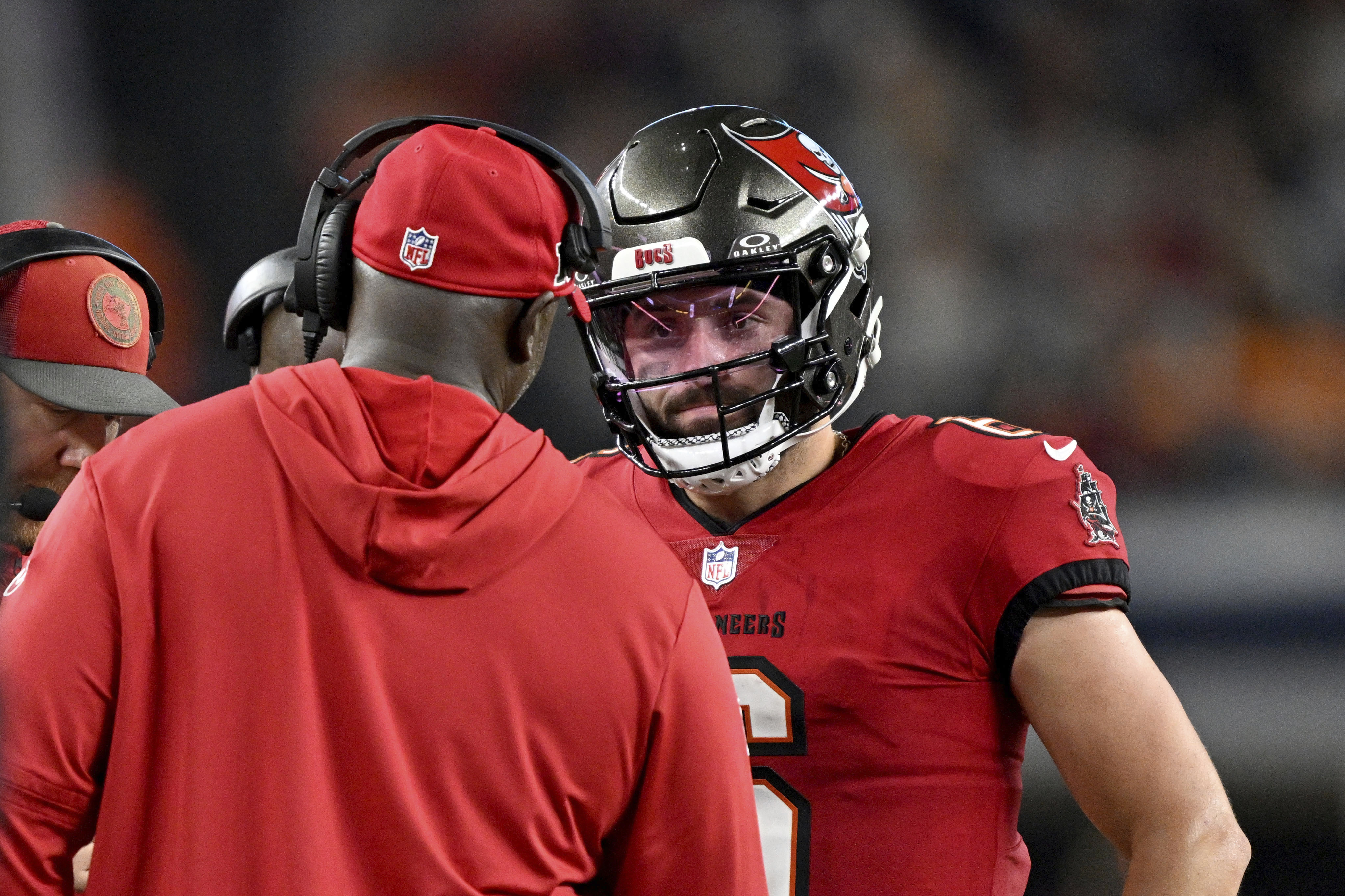 Tampa Bay Buccaneers head coach Todd Bowles, left, talks with quarterback Baker Mayfield, right, late in the second half of an NFL football game against the Dallas Cowboys in Arlington, Texas, Sunday, Dec. 22, 2024. 