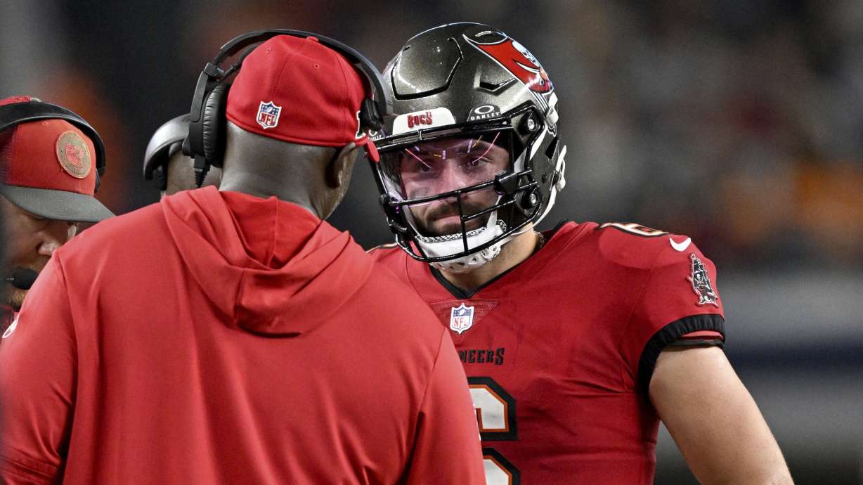 Tampa Bay Buccaneers head coach Todd Bowles, left, talks with quarterback Baker Mayfield, right, late in the second half of an NFL football game against the Dallas Cowboys in Arlington, Texas, Sunday, Dec. 22, 2024.