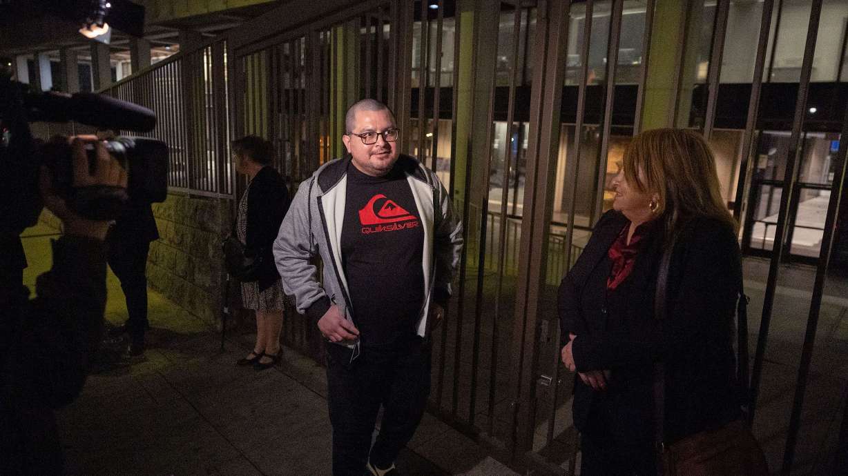 Lombardo Palacios, left, who was 15 when he was arrested, walks out of court a free man with his mother, Carla Campos, on Friday.
