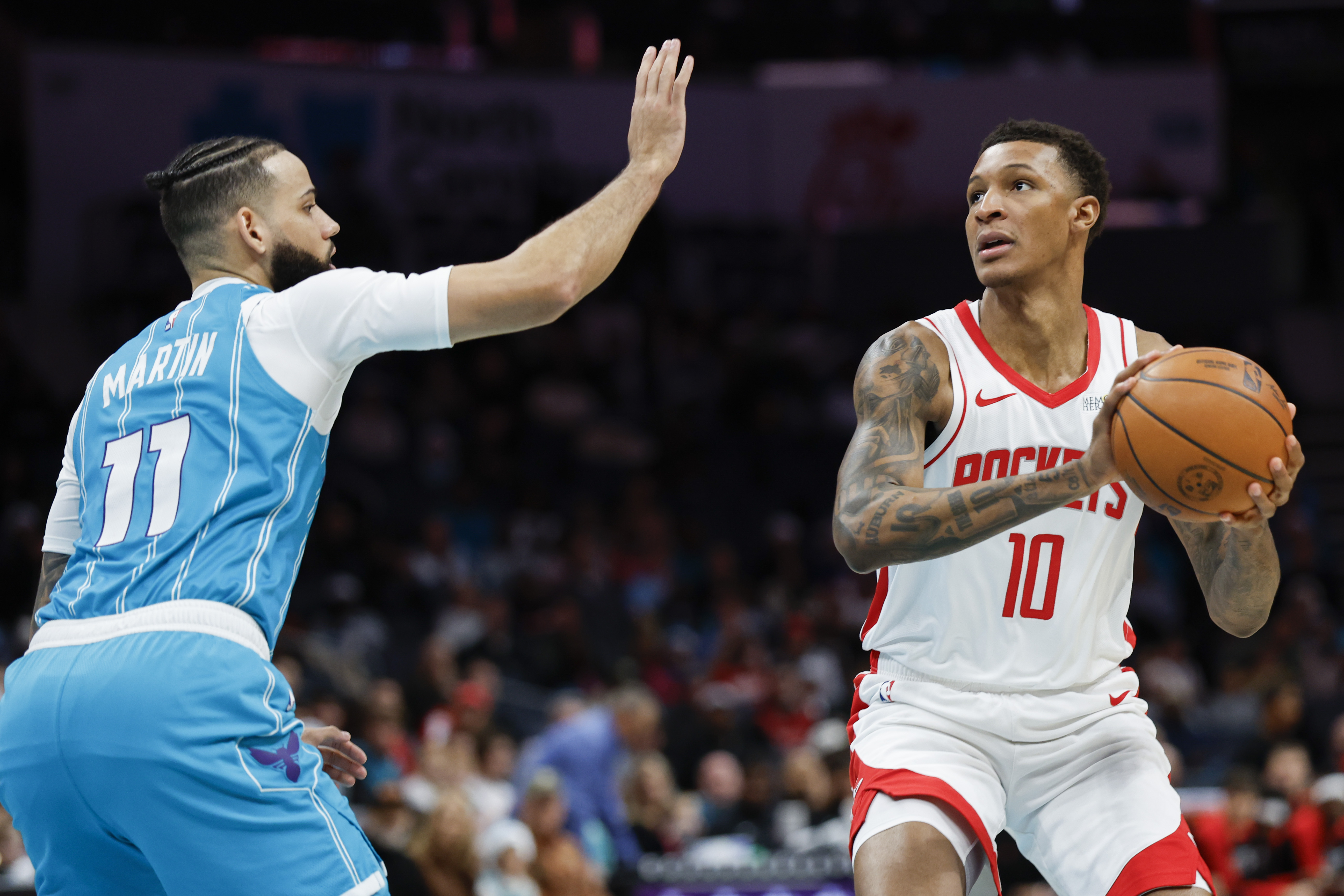 Houston Rockets forward Jabari Smith Jr. (10) looks to shoot against Charlotte Hornets forward Cody Martin (11) during the first half of an NBA basketball game in Charlotte, N.C., Monday, Dec. 23, 2024. 