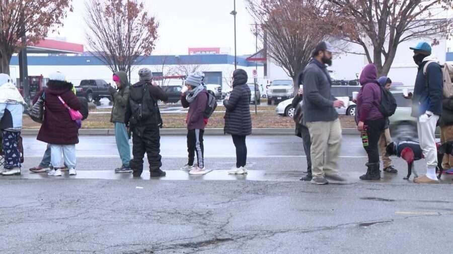 People stand in line at the Salt Lake Rescue Mission on Monday. The Rescue Mission of Salt Lake said 2,876 Utahns experience homelessness each night.