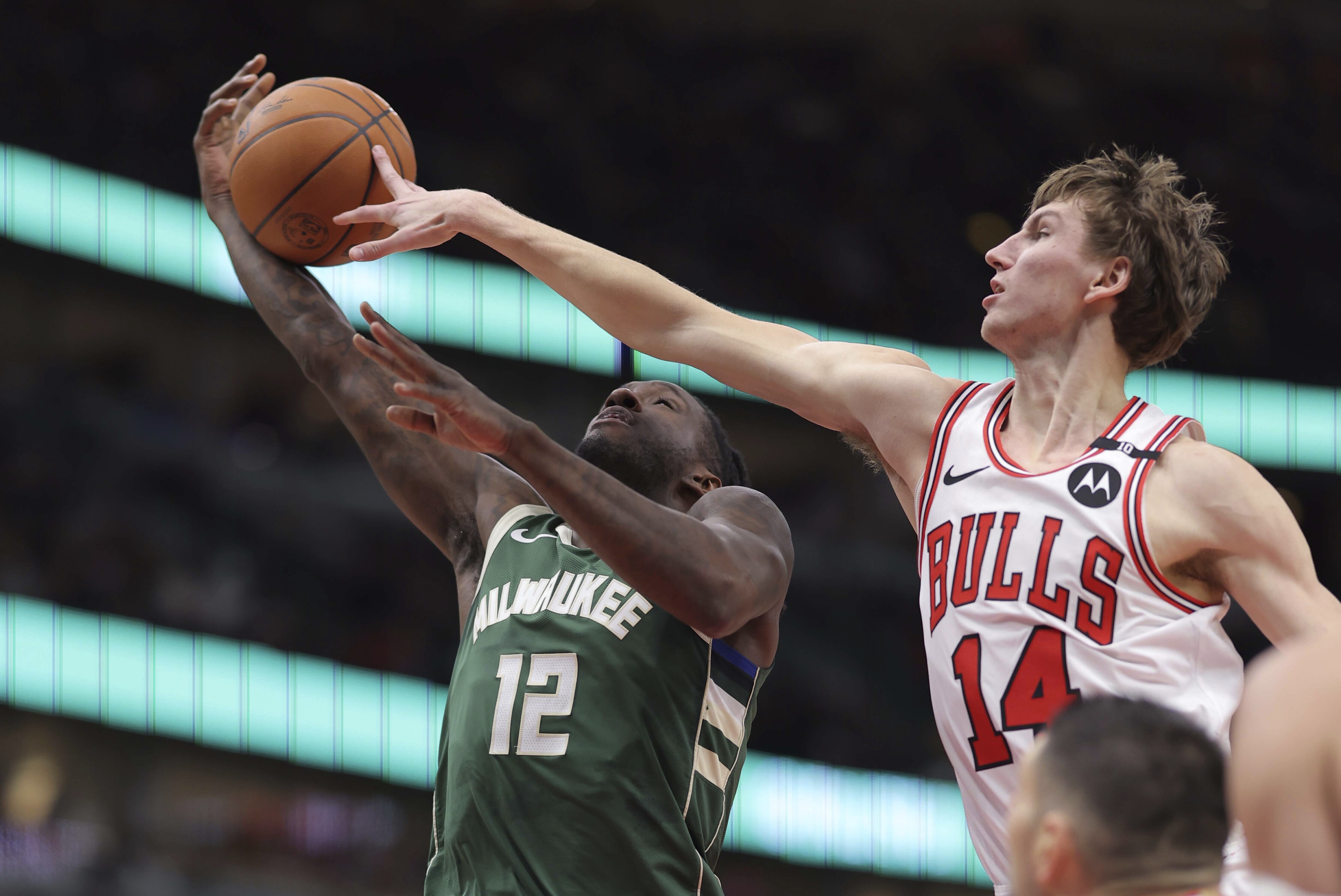 Chicago Bulls forward Matas Buzelis (14) blocks Milwaukee Bucks forward Taurean Prince (12) layup during the first half of an NBA basketball game Monday, Dec. 23, 2024, in Chicago. 