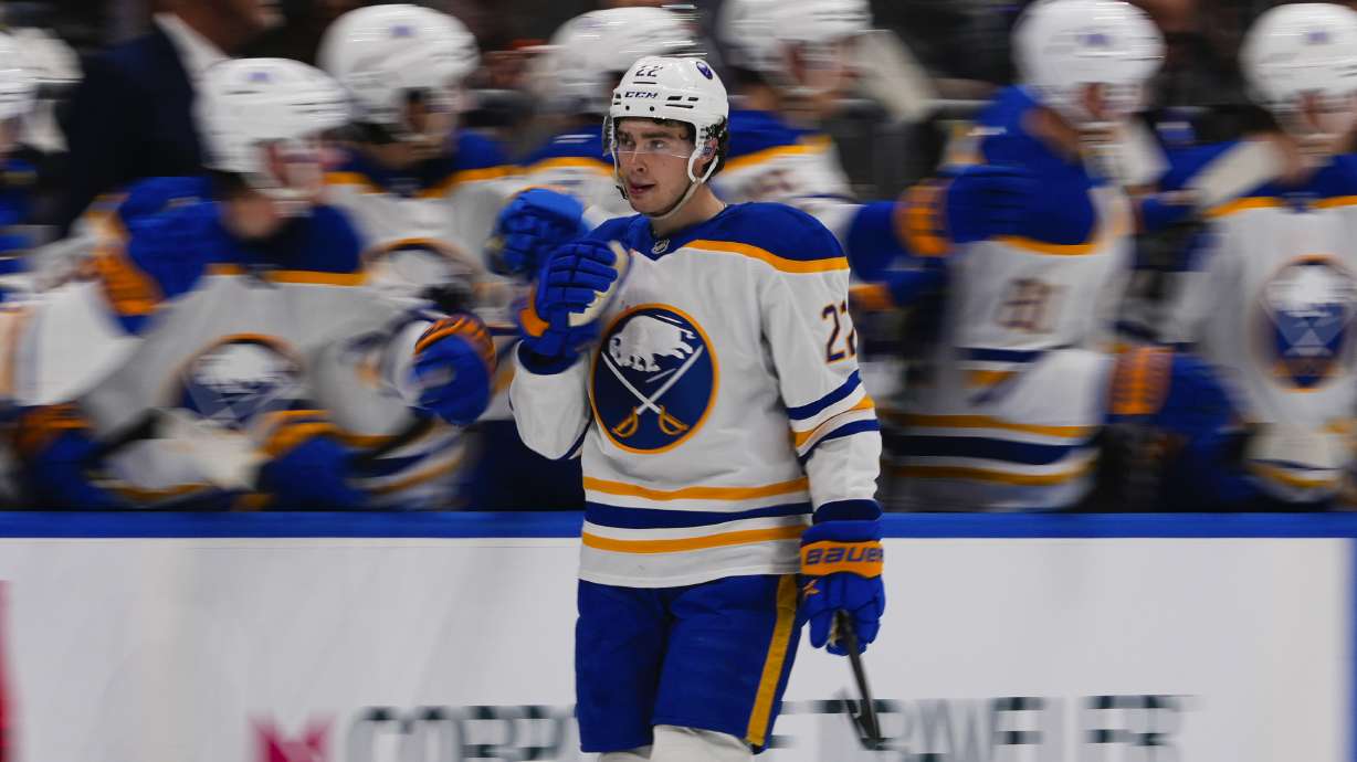 Buffalo Sabres' Jack Quinn (22) celebrates with teammates after scoring a goal during the second period of an NHL hockey game against the New York Islanders Monday, Dec. 23, 2024, in Elmont, N.Y.