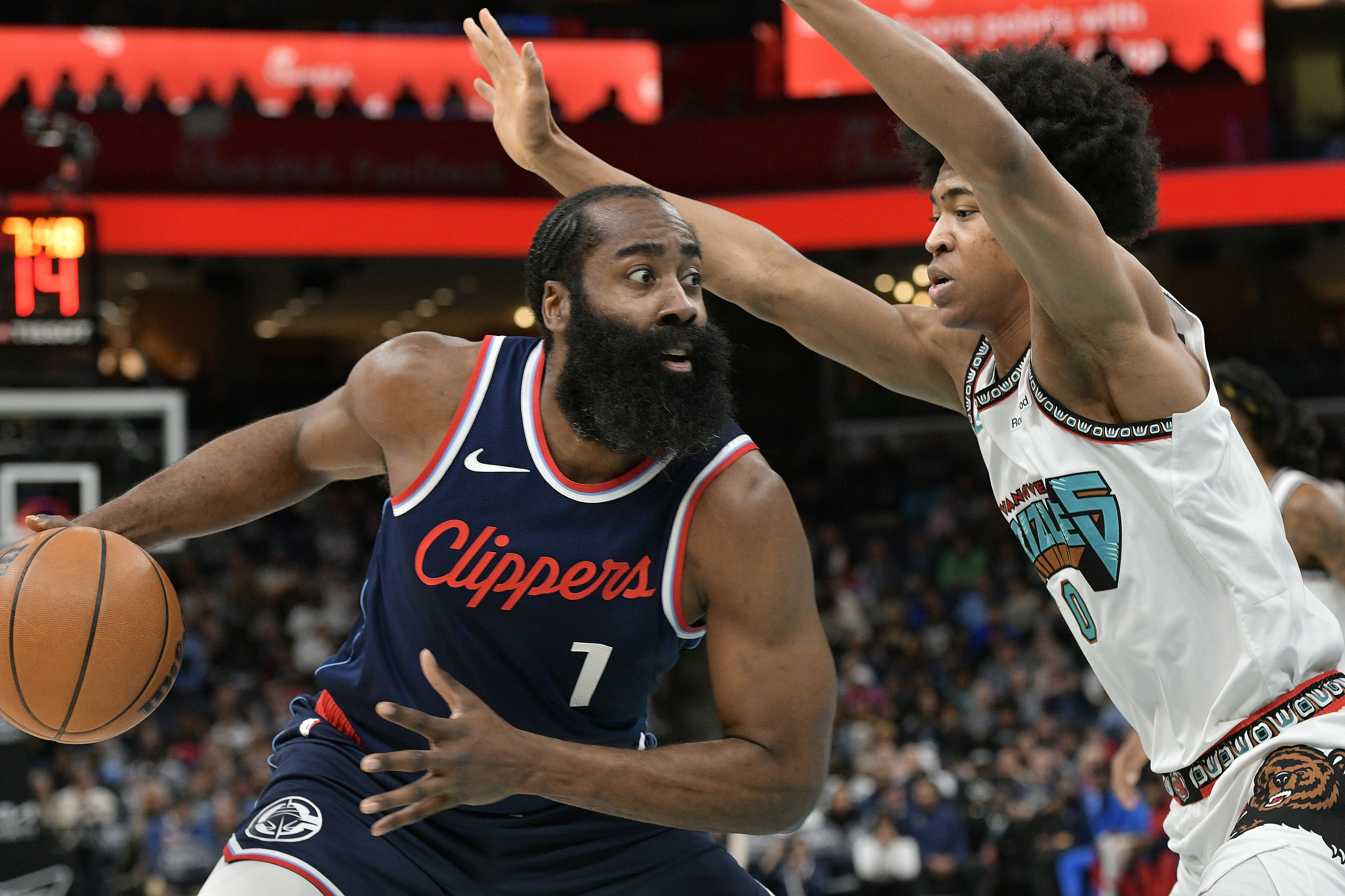 Los Angeles Clippers guard James Harden (1) handles the ball against Memphis Grizzlies forward Jaylen Wells (0) in the first half of an NBA basketball game Monday, Dec. 23, 2024, in Memphis, Tenn. 