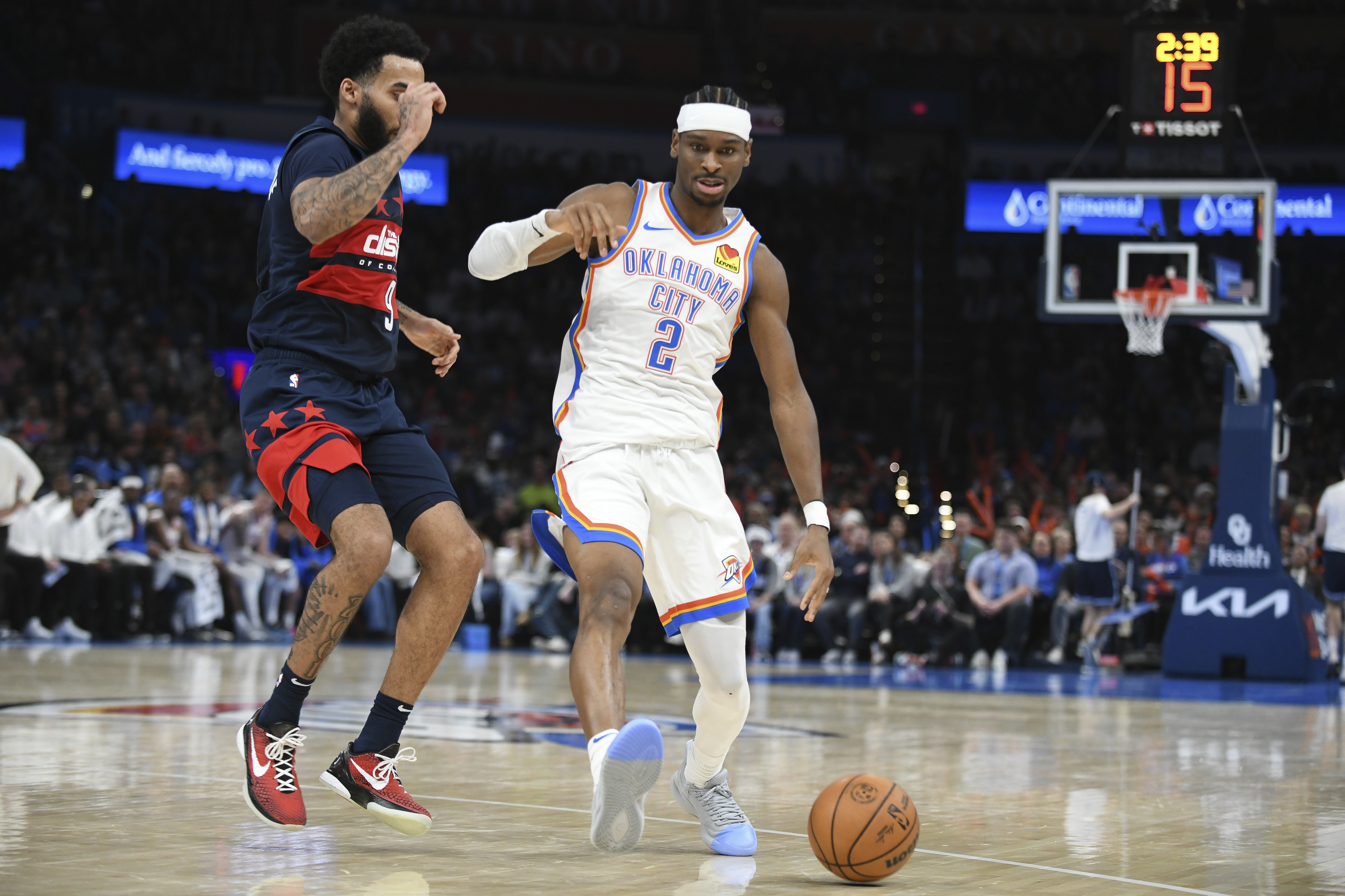 Oklahoma City Thunder guard Shai Gilgeous-Alexander (2) pushes past Washington Wizards forward Justin Champagnie during the second half of an NBA basketball game, Monday, Dec. 23, 2024, in Oklahoma City.