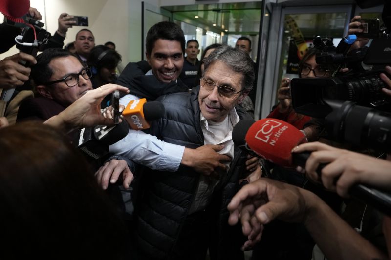 Media swarm Fabio Ochoa, center, a former member of Cartel of Medellin, upon his arrival at El Dorado airport, after being deported from the United States, in Bogota, Colombia, Monday.