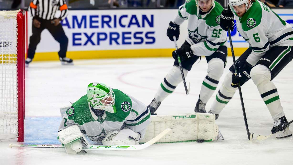 Dallas Stars goaltender Casey DeSmith (1) makes a save with his leg during the first period of an NHL hockey game against the Utah Hockey Club, Monday, Dec. 23, 2024, in Salt Lake City.