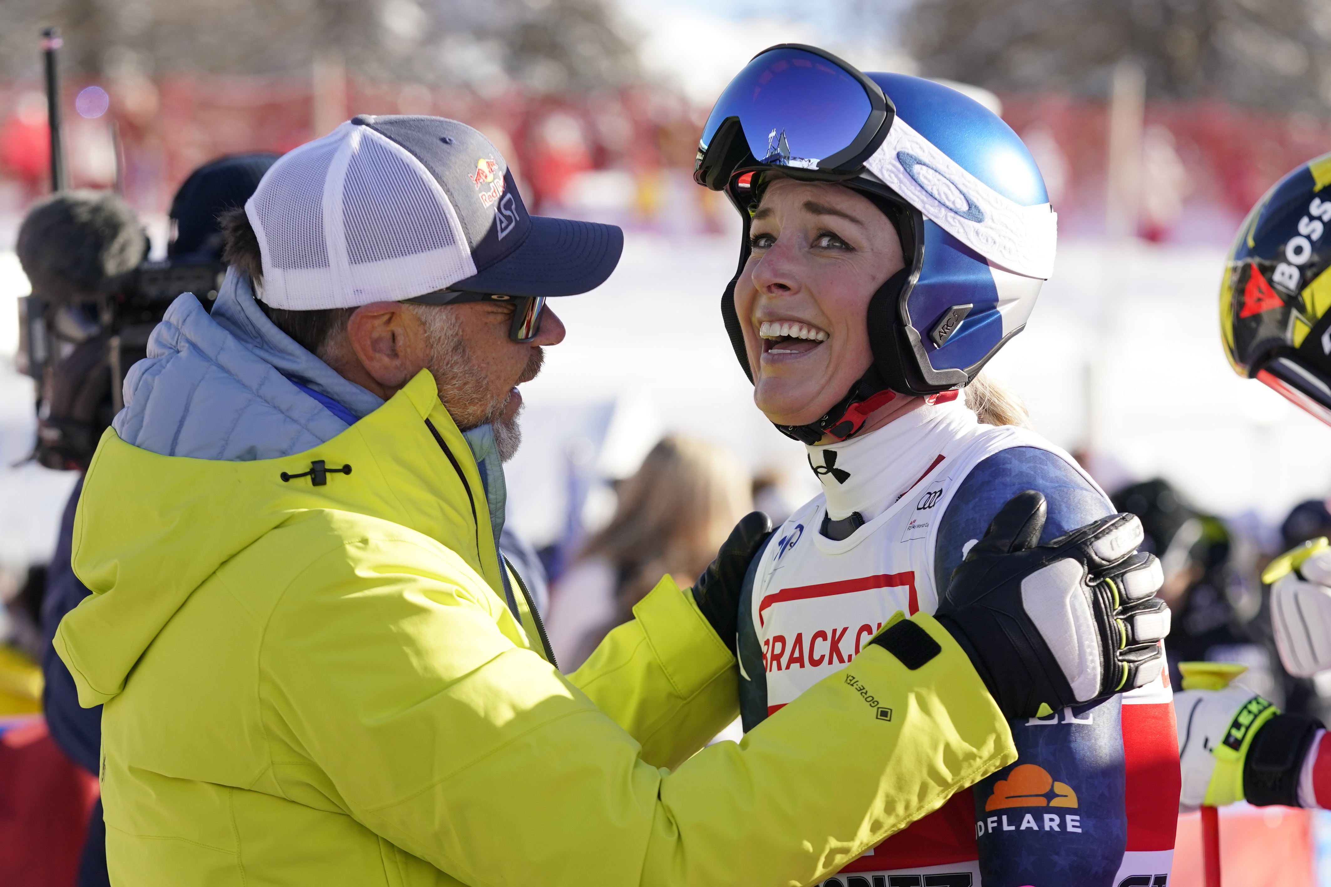 United States' Lindsey Vonn, right, is congratulated by Red Bull Head of Athletes Special Projects Patrick Riml after she competed in an alpine ski, women's World Cup super G, in St. Moritz, Switzerland, Saturday, Dec. 21, 2024. 