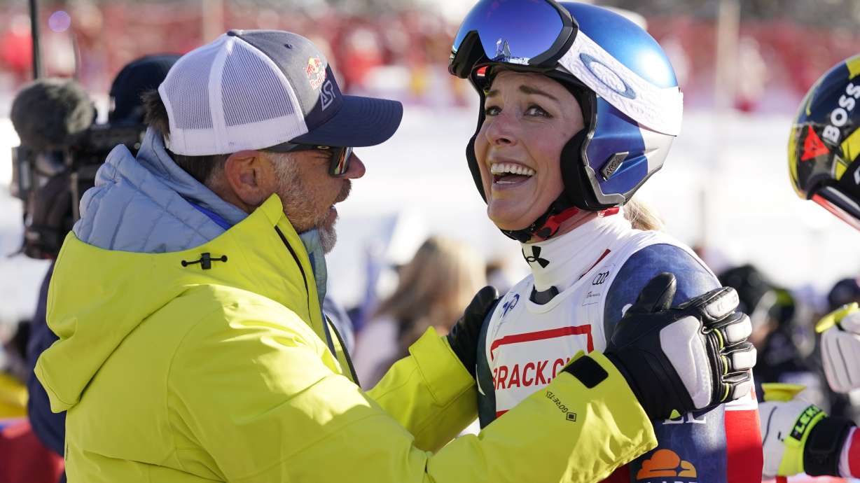 United States' Lindsey Vonn, right, is congratulated by Red Bull Head of Athletes Special Projects Patrick Riml after she competed in an alpine ski, women's World Cup super G, in St. Moritz, Switzerland, Saturday, Dec. 21, 2024.