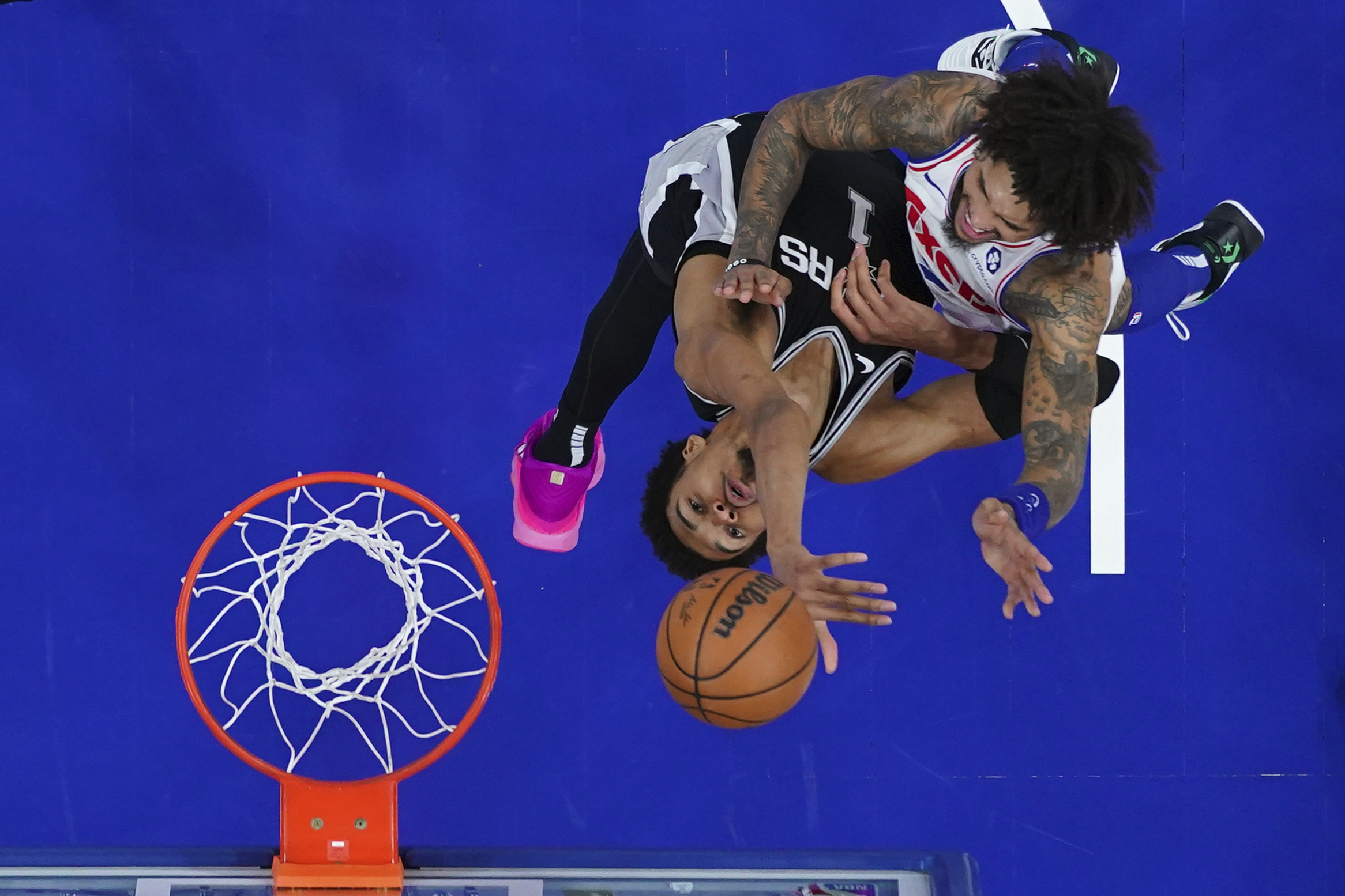 Philadelphia 76ers' Kelly Oubre Jr., right, goes up for a shot against San Antonio Spurs' Victor Wembanyama during the second half of an NBA basketball game, Monday, Dec. 23, 2024, in Philadelphia.