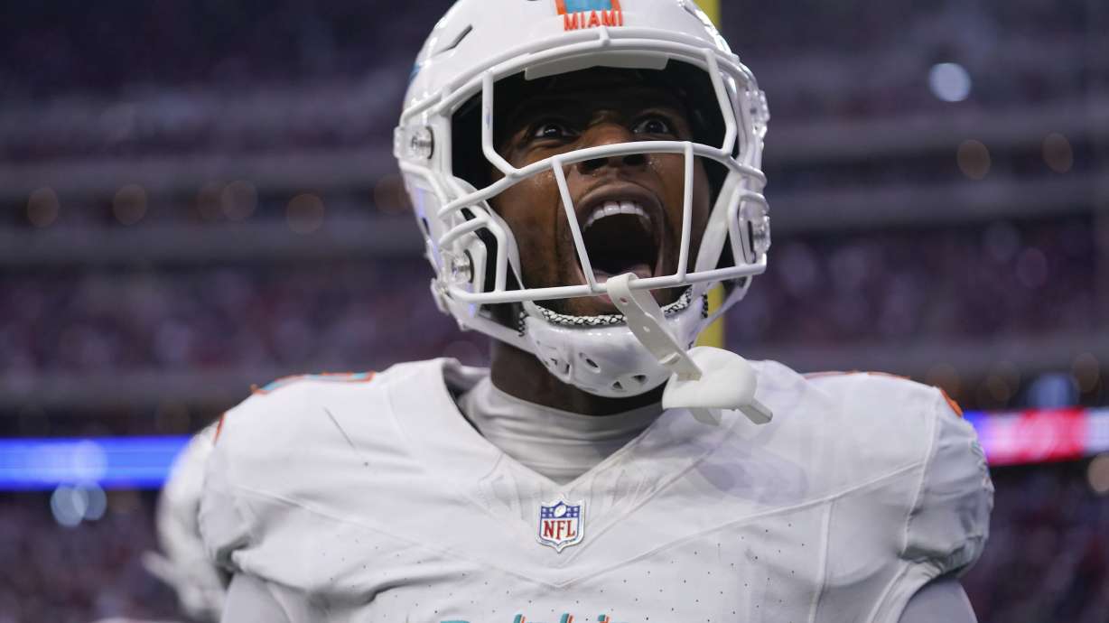 Miami Dolphins tight end Jonnu Smith (9) celebrates scoring a touchdown during the second half of an NFL football game against the Houston Texans, Sunday, Dec. 15, 2024, in Houston.