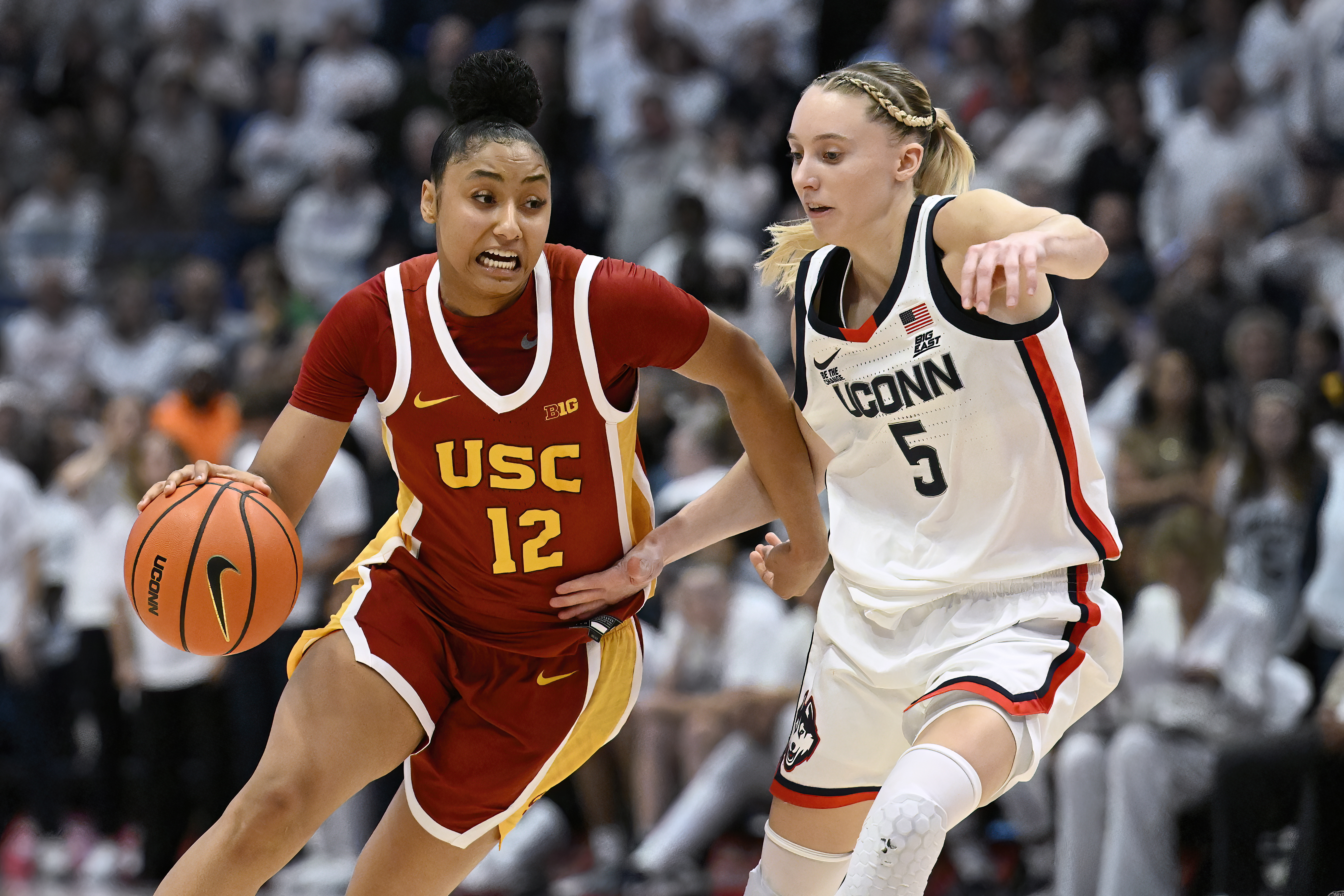 Southern California guard JuJu Watkins (12) is guarded by UConn guard Paige Bueckers (5) in the second half of an NCAA college basketball game, Saturday, Dec. 21, 2024, in Hartford, Conn.