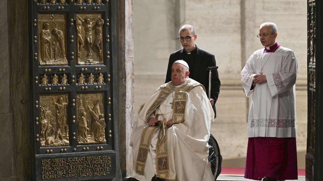 Pope Francis opens the Holy Door of St Peter's Basilica to mark the start of the Catholic Jubilee Year, at the Vatican, Christmas Eve.