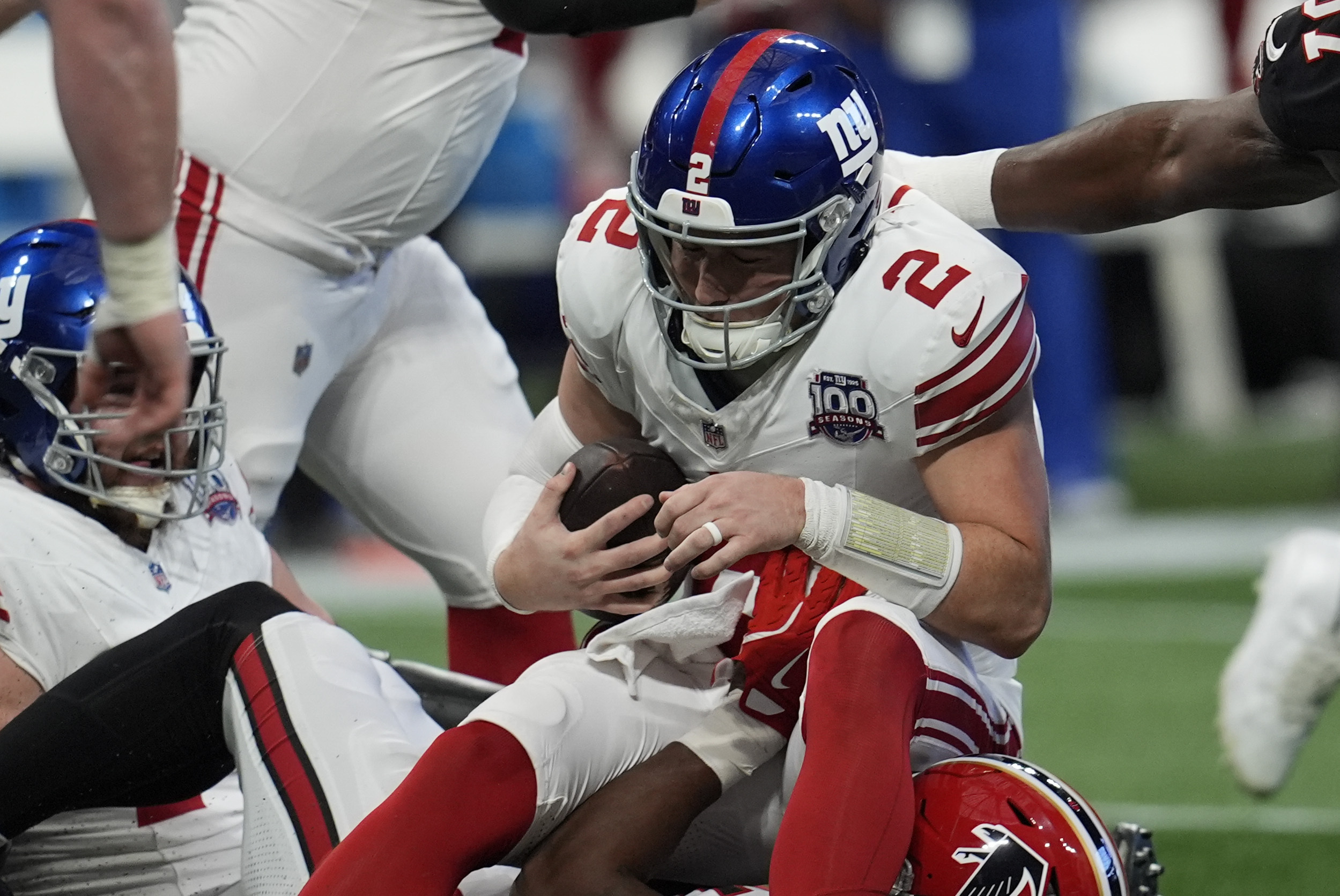 New York Giants quarterback Drew Lock (2) is sacked by Atlanta Falcons linebacker Arnold Ebiketie (17) in the first half of an NFL football game in Atlanta, Sunday, Dec. 22, 2024.