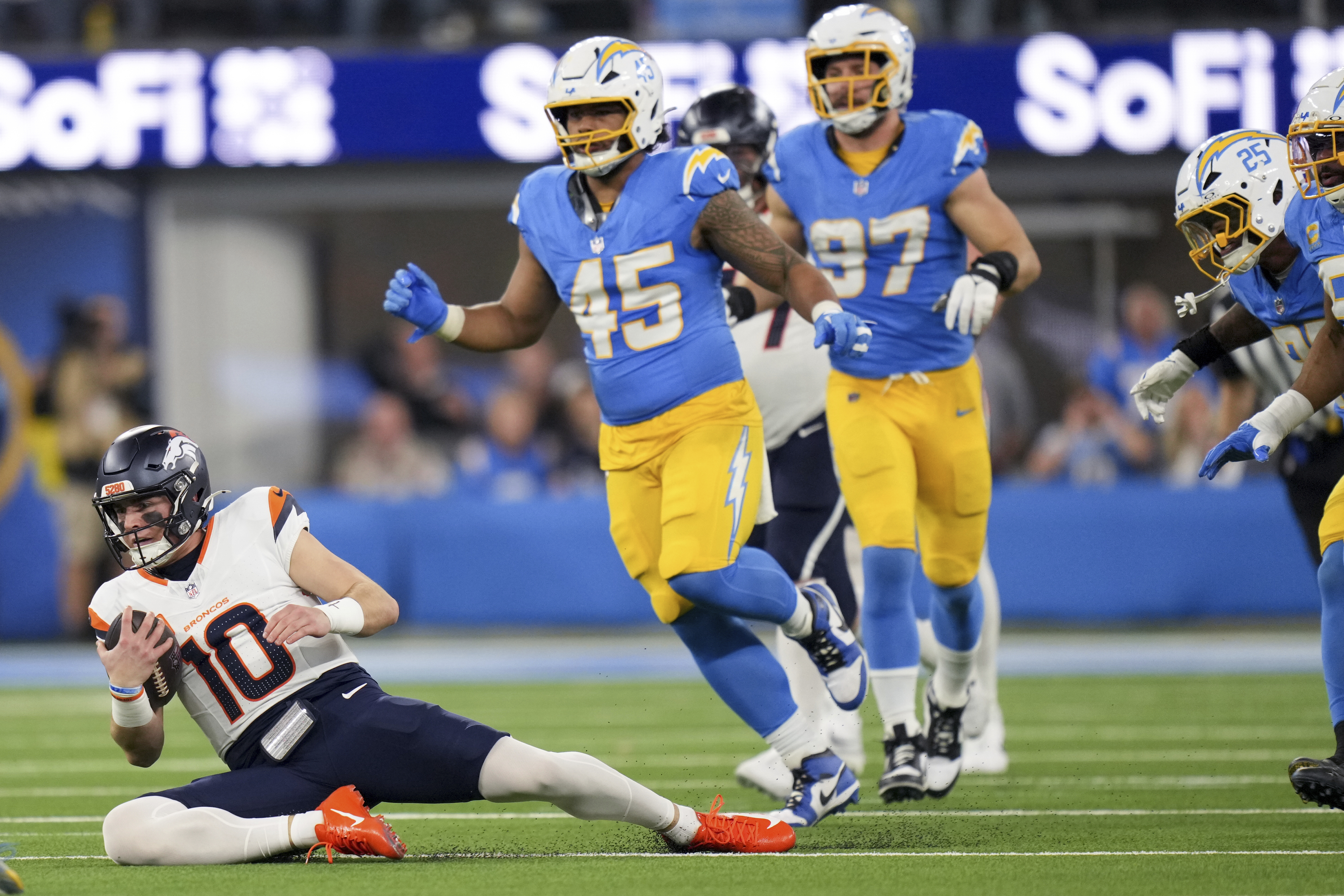 Denver Broncos quarterback Bo Nix (10) slides after gaining yards during the first half an NFL football game against the Los Angeles Chargers, Thursday, Dec. 19, 2024, in Inglewood, Calif.