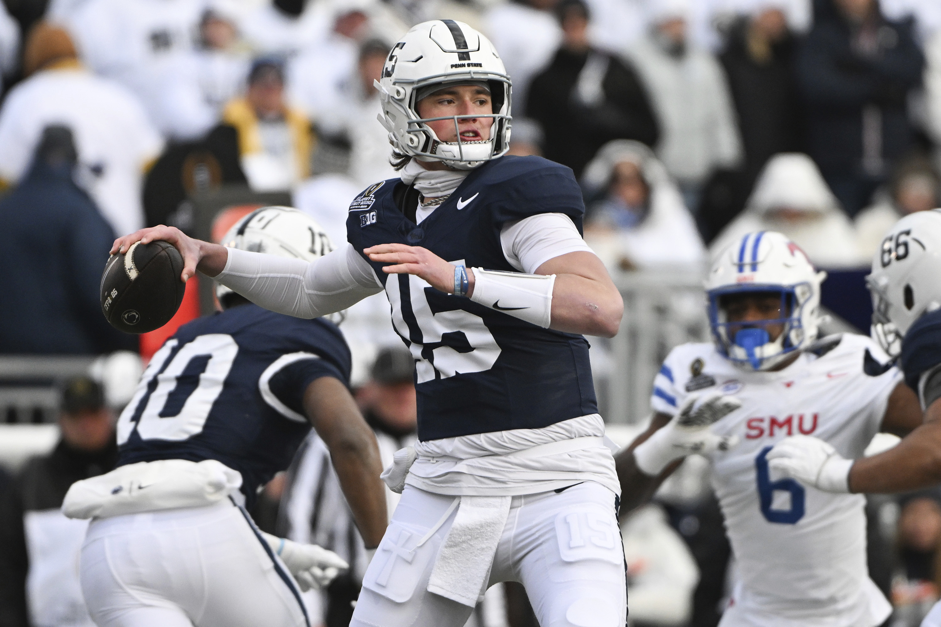 Penn State quarterback Drew Allar (15) throws a pass while being pressured by SMU defensive end Jahfari Harvey (6) during the first half in the first round of the NCAA College Football Playoff, Saturday, Dec. 21, 2024, in State College, Pa. 