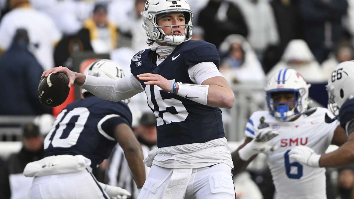 Penn State quarterback Drew Allar (15) throws a pass while being pressured by SMU defensive end Jahfari Harvey (6) during the first half in the first round of the NCAA College Football Playoff, Saturday, Dec. 21, 2024, in State College, Pa.