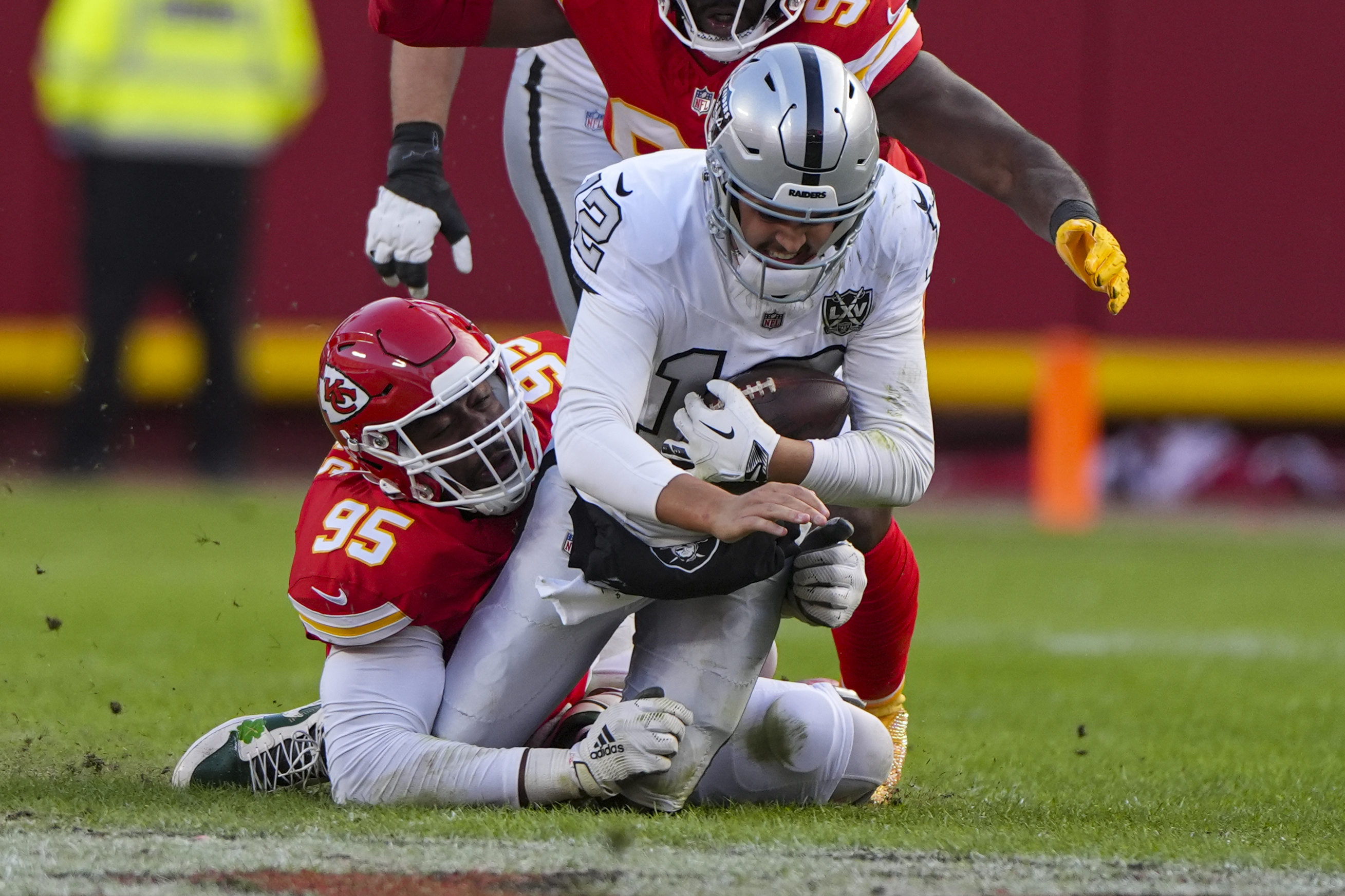 Las Vegas Raiders quarterback Aidan O'Connell (12) is sacked by Kansas City Chiefs defensive tackle Chris Jones (95) during the first half of an NFL football game in Kansas City, Mo., Friday, Nov. 29, 2024.